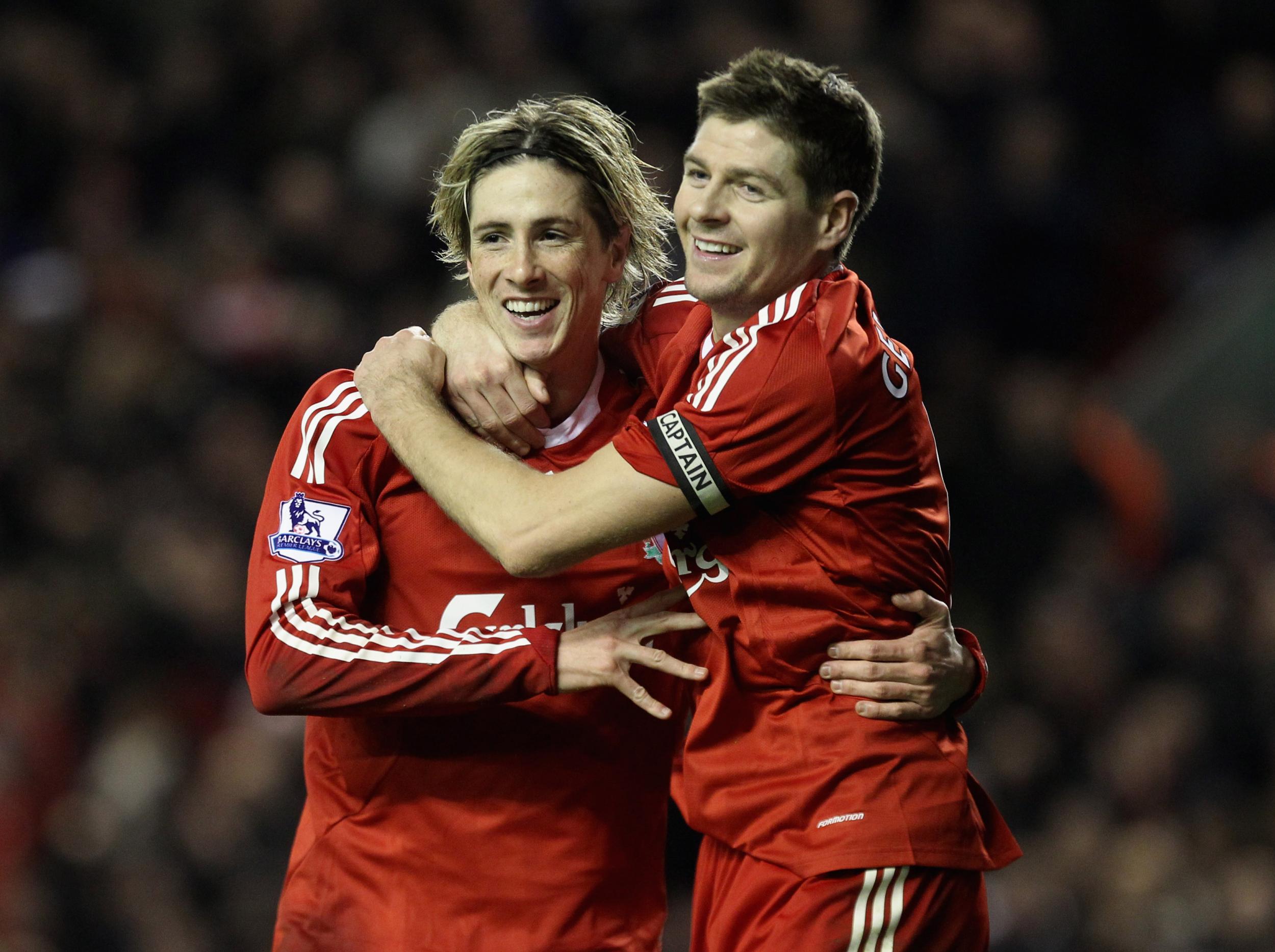 Torres is congratulated by Gerrard after his goal against Wigan in December 2009