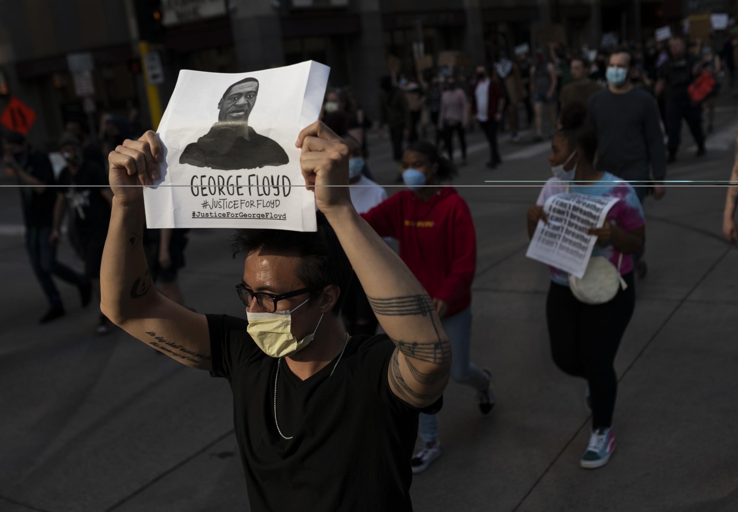 Protesters march through the street in downtown Minneapolis, Minnesota