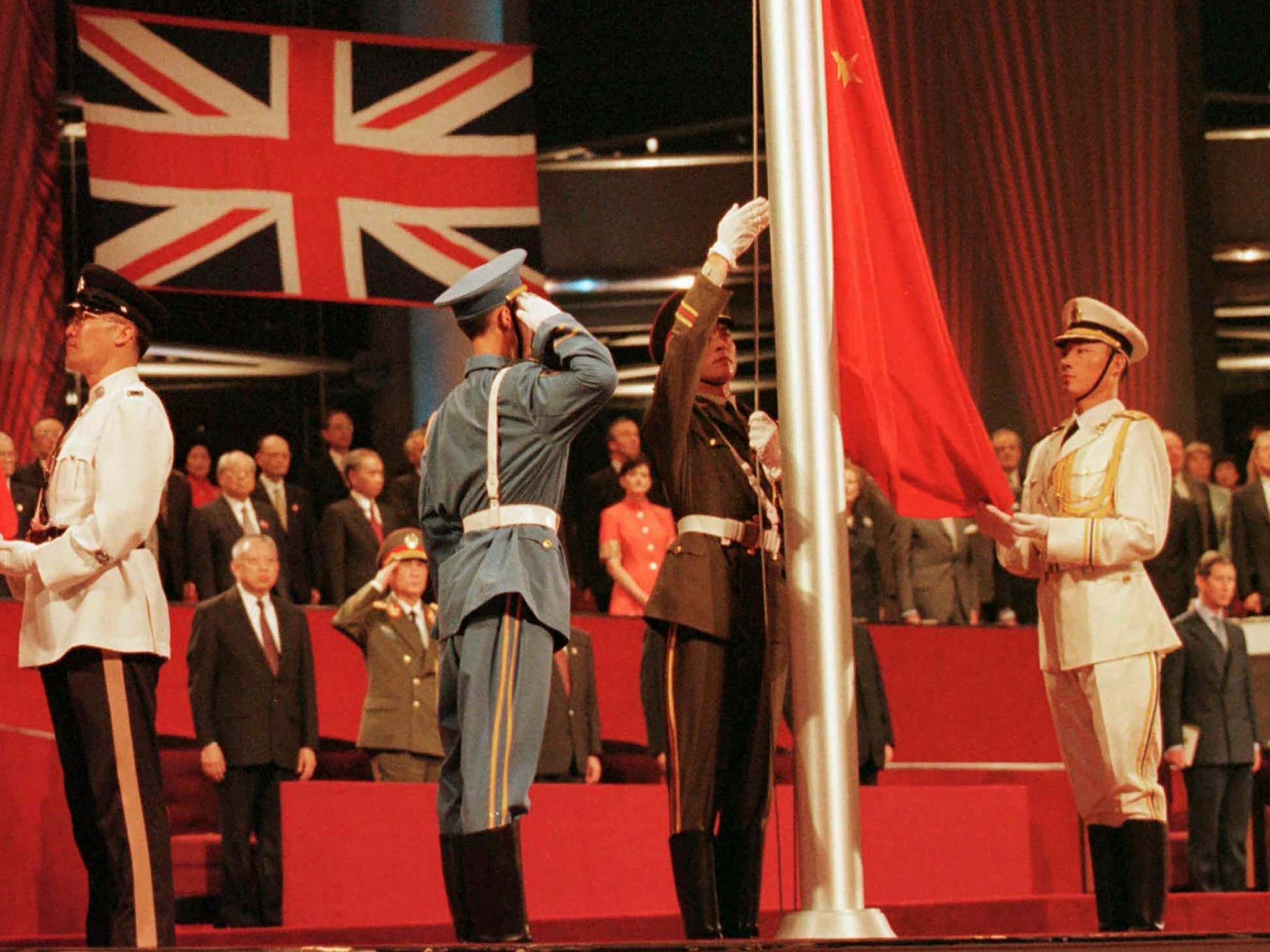 Chinese soldiers raise the country’s flag at the Hong Kong convention centre to mark the moment the British colony reverted to Chinese rule in July 1997