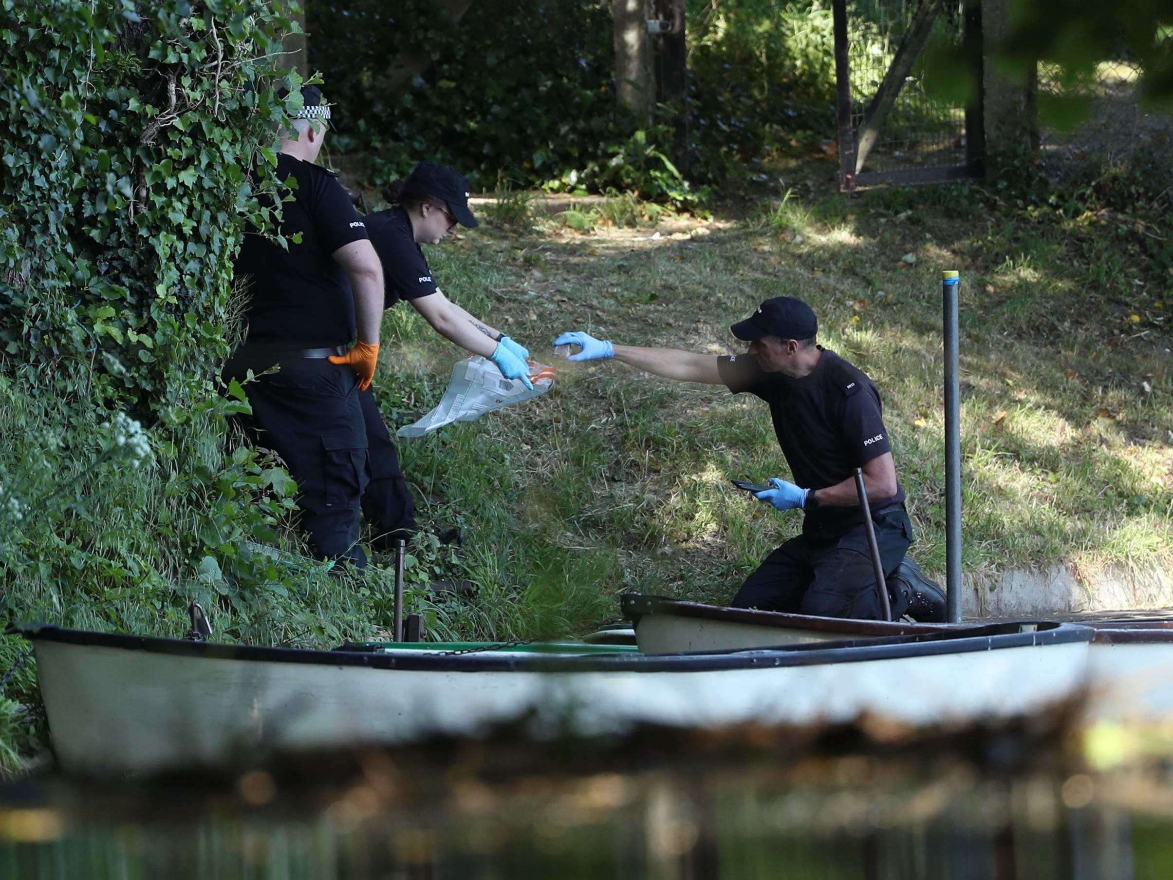 Police forensic officers gather evidence near the boats by the lake on the grounds of Lullingstone Castle in Eynsford, Kent