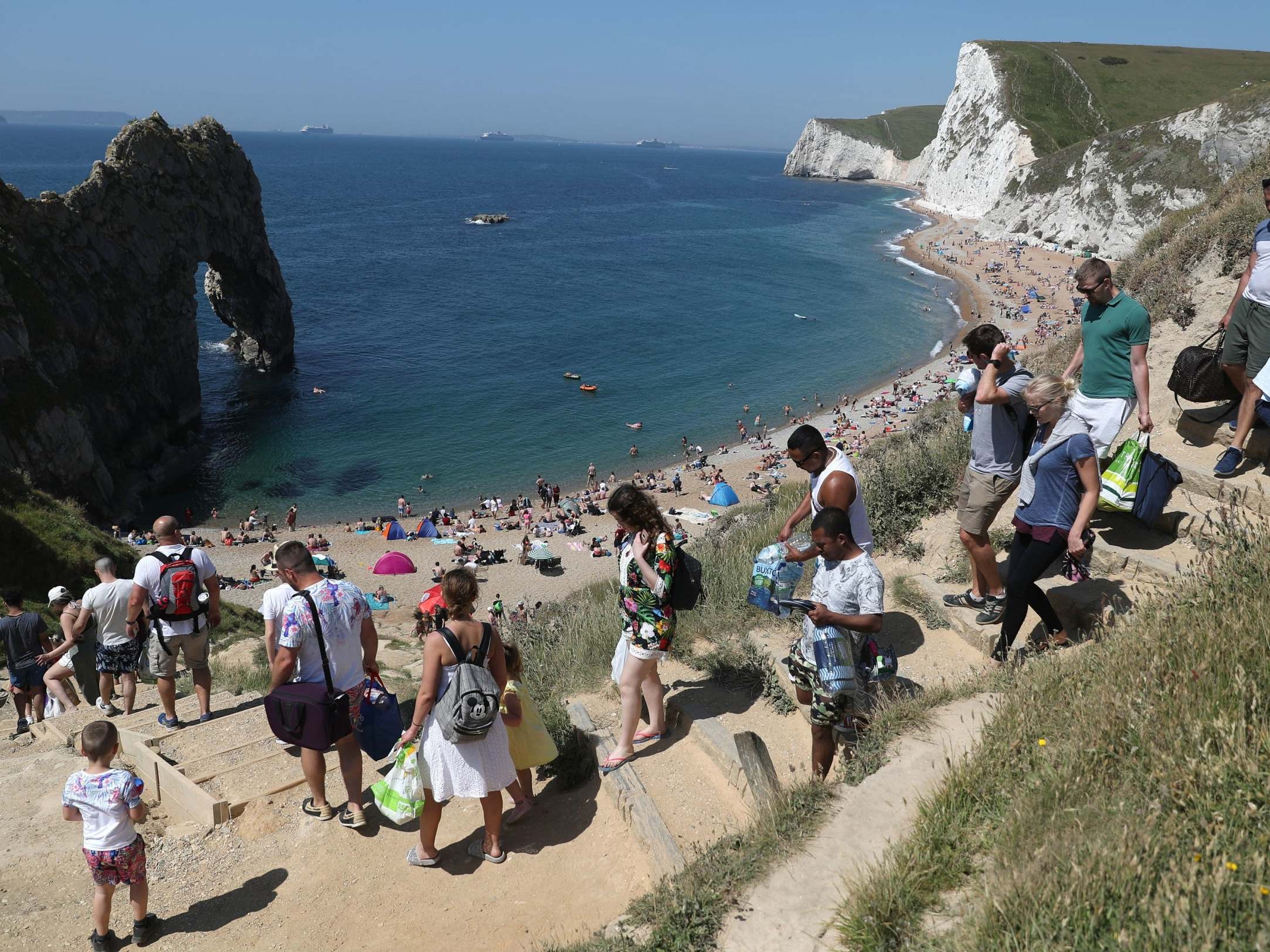 People make their way down to the sea at Durdle Door, Dorset (PA Wire)