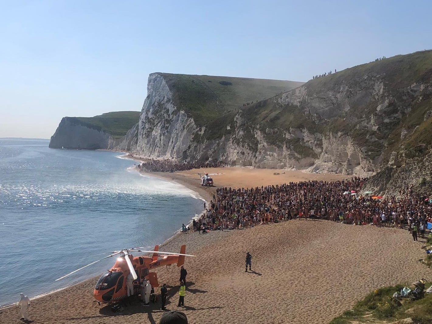 An air ambulance lands on the beach at Durdle Door as the is evacuated