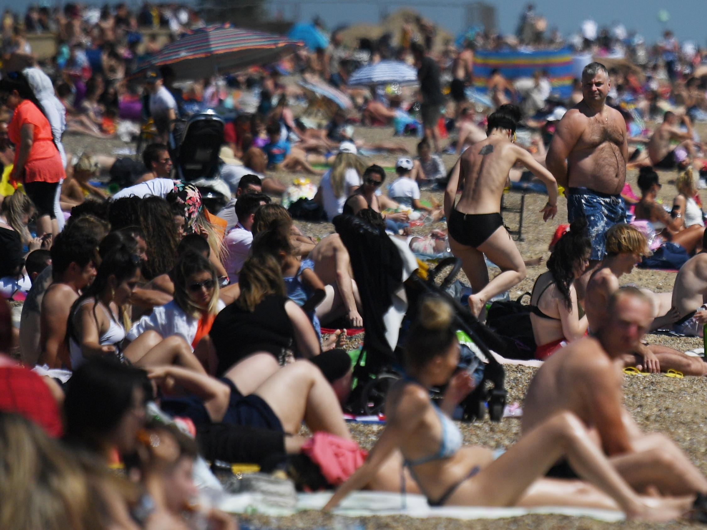 People enjoy the sunshine on the beach at Southend-On-Sea in Essex on Saturday (EPA/NEIL HALL)