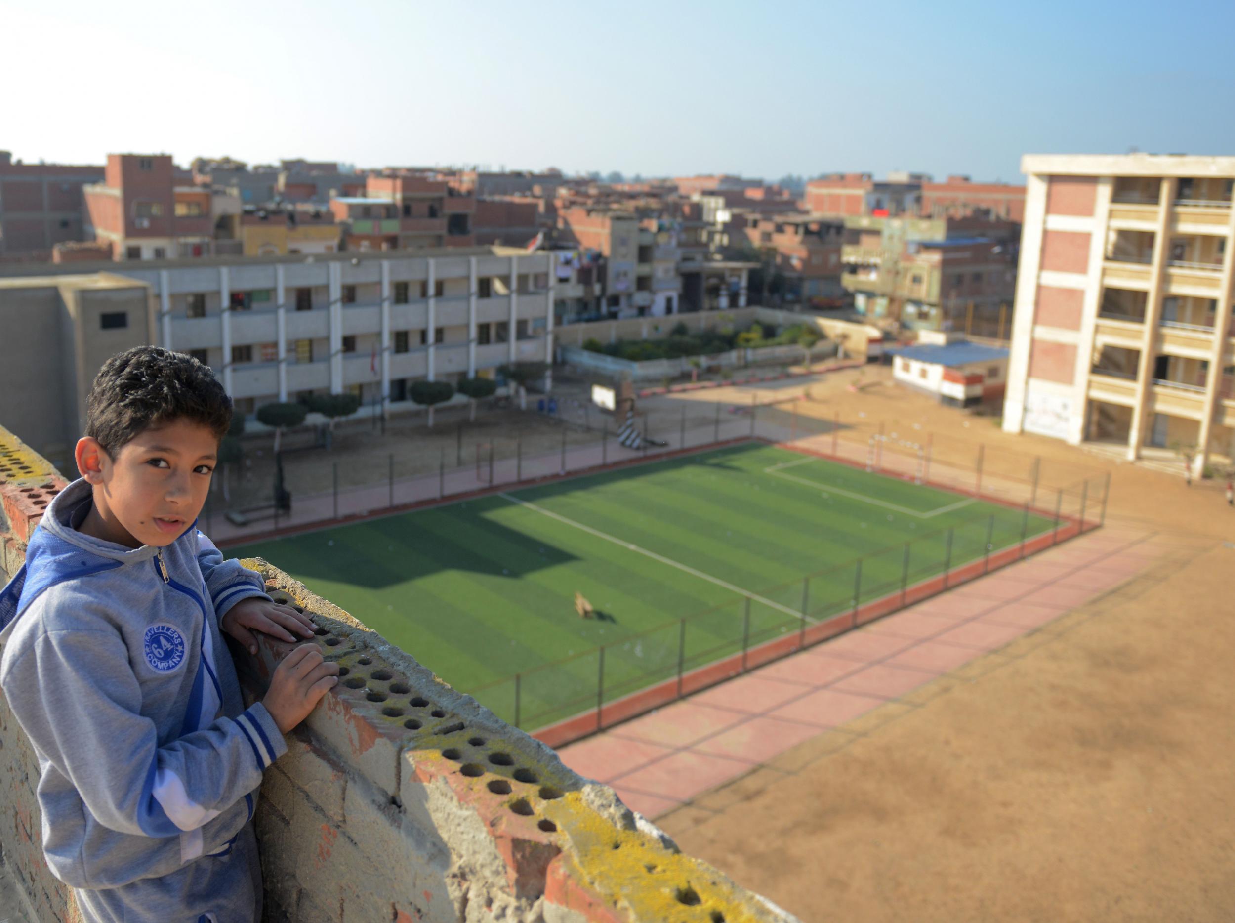 A young boy stands by the Nagrig campus where Salah once studied