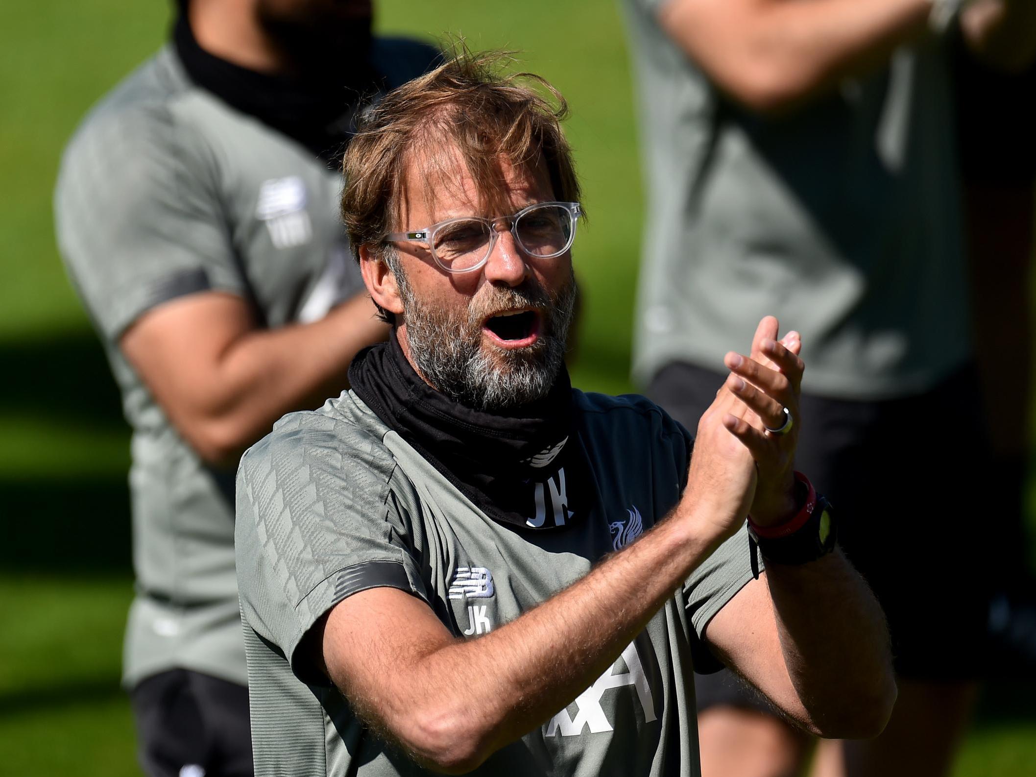 Klopp applauds during Liverpool training