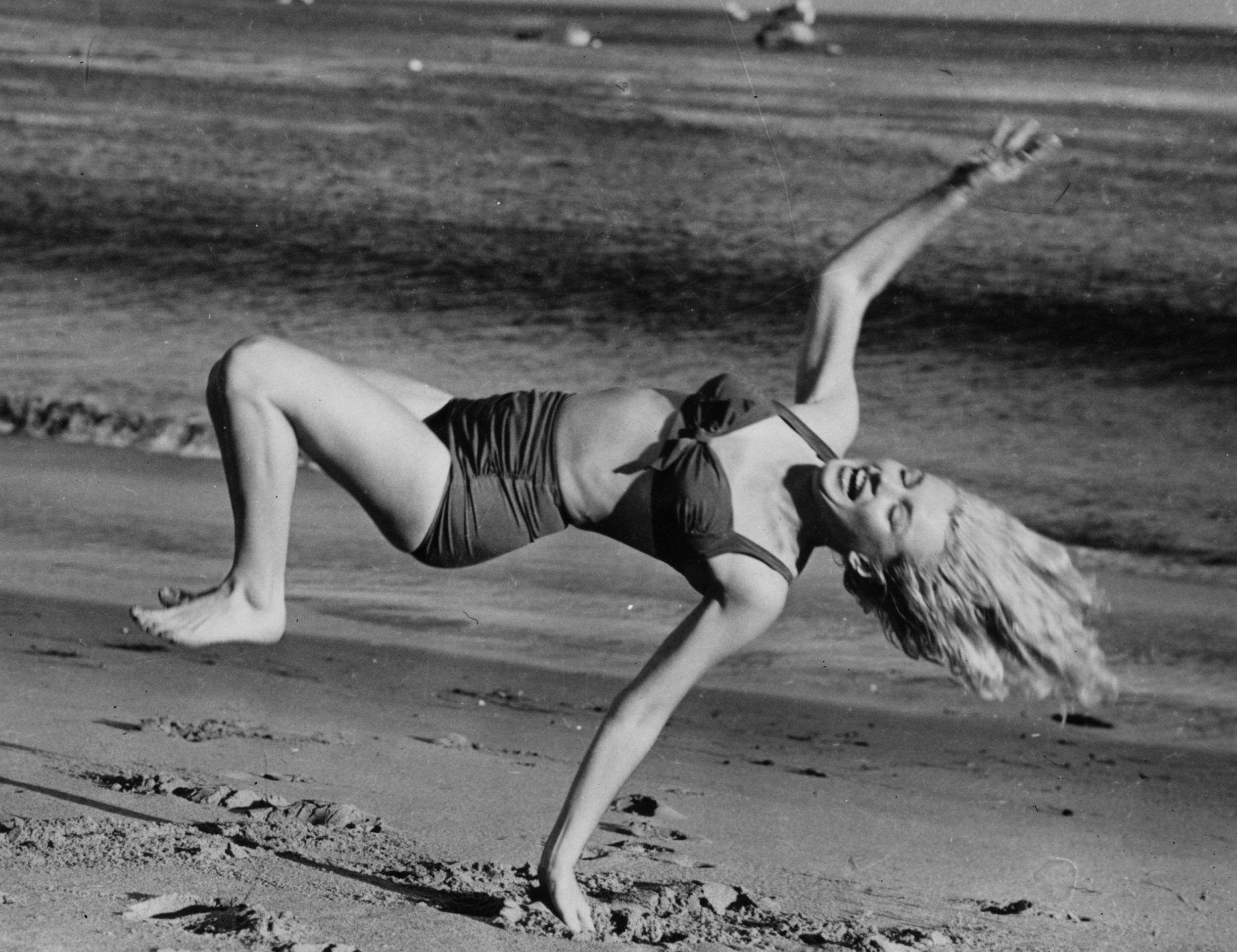 Marilyn Monroe having fun on the beach near her Hollywood home during a break from filming