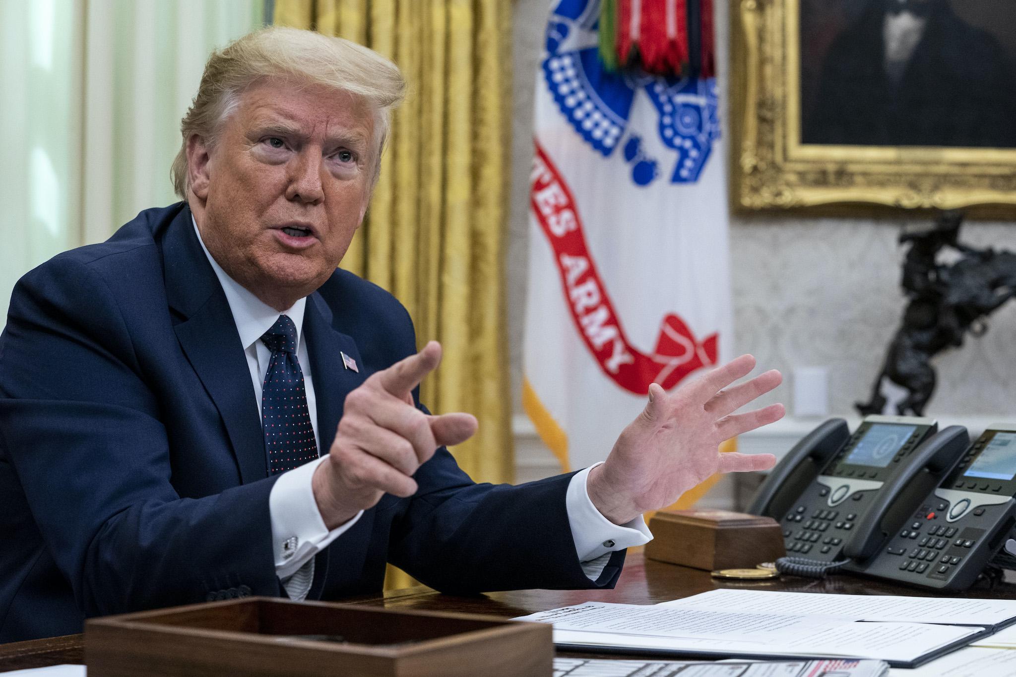 President Donald Trump with Attorney General William Barr, make remarks before signing an executive order in the Oval Office that will punish Facebook, Google and Twitter for the way they police content online