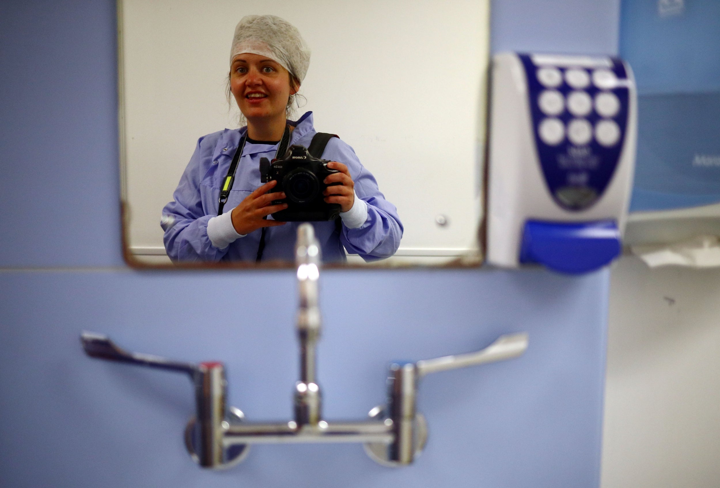 McKay takes a picture of herself wearing PPE before entering the laundry and linen room at the Royal Blackburn Teaching Hospital