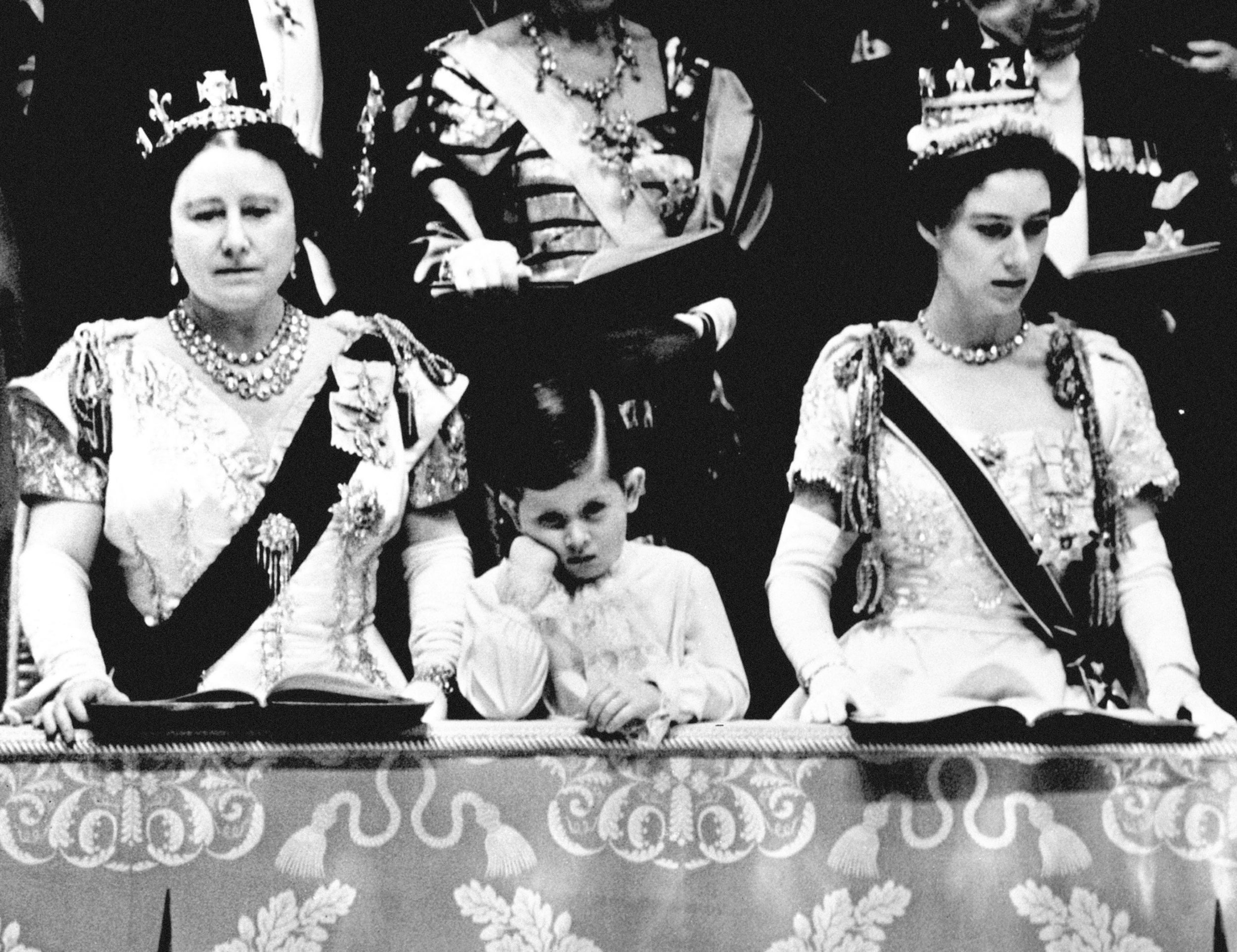 Prince Charles looking solemn as he stands between the Queen Mother and Princess Margaret in the Royal Box at Westminster Abbey, from where he watched the Queen crowned