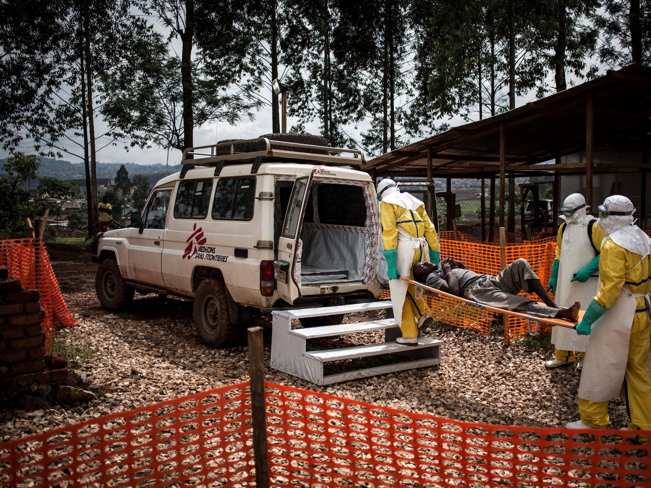 Health workers move a patient in Butembo to a hospital after he was cleared of having Ebola