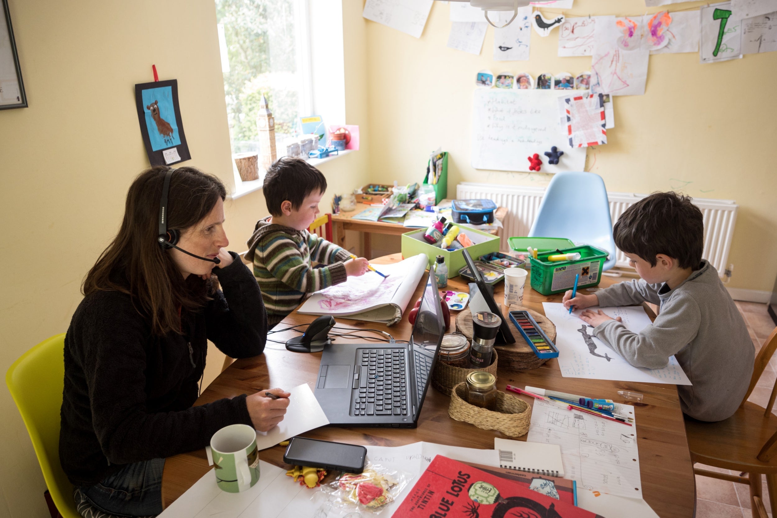 Three-year-old Espen and his six-year-old brother Leo complete their homeschooling work as their mother Moira, a regional council employee, works from their home in Marsden