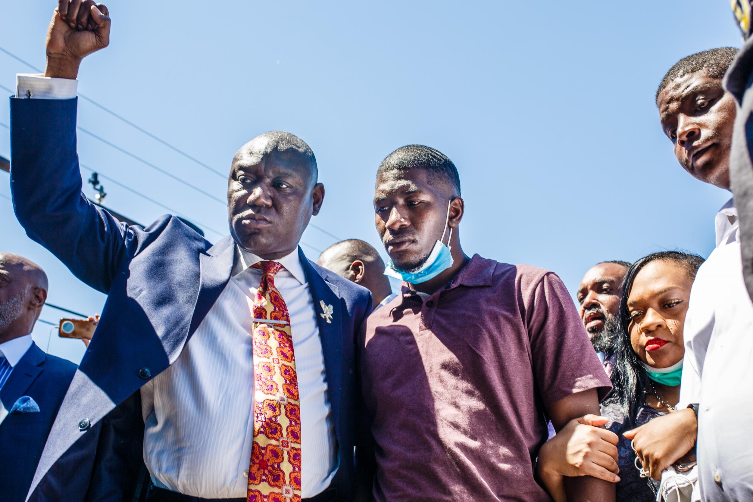 George Floyd's son Quincy Mason Floyd, family attorney Ben Crump other family members visit the site of Mr Floyd's death in Minneapolis on 3 June.