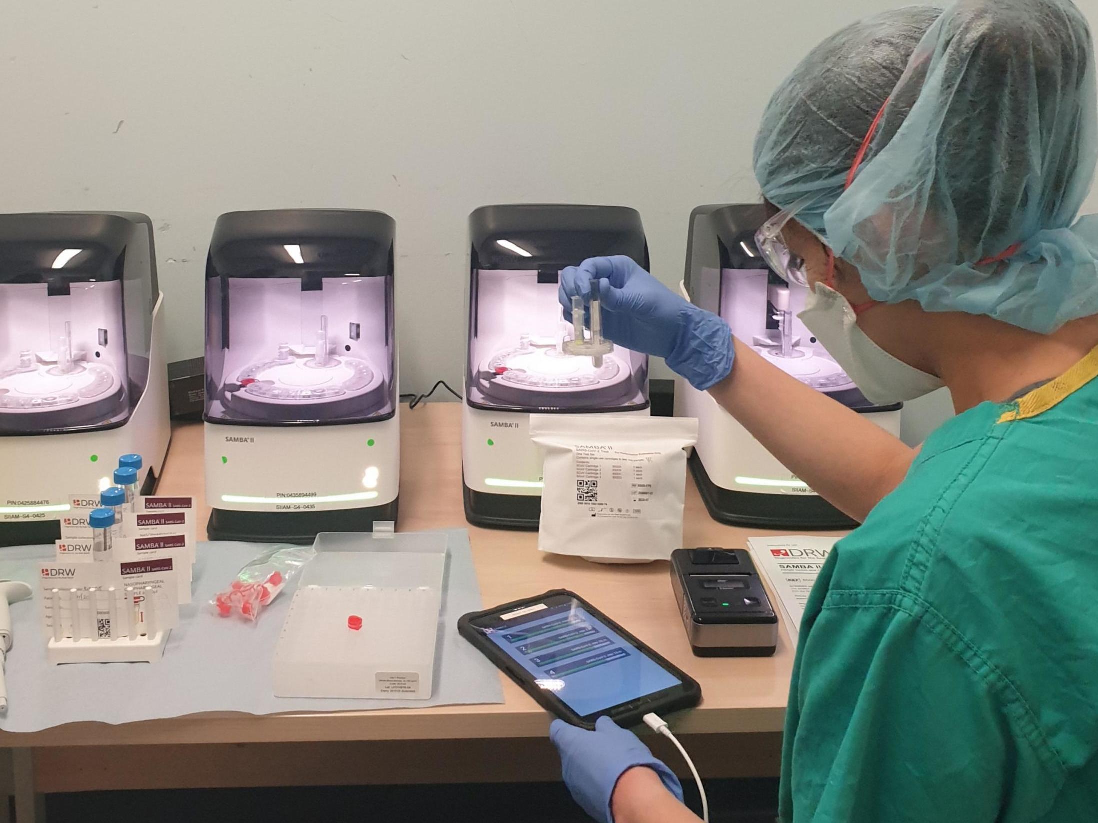 A research nurse processes patient samples using the Samba II machines at Addenbrooke's Hospital in Cambridge