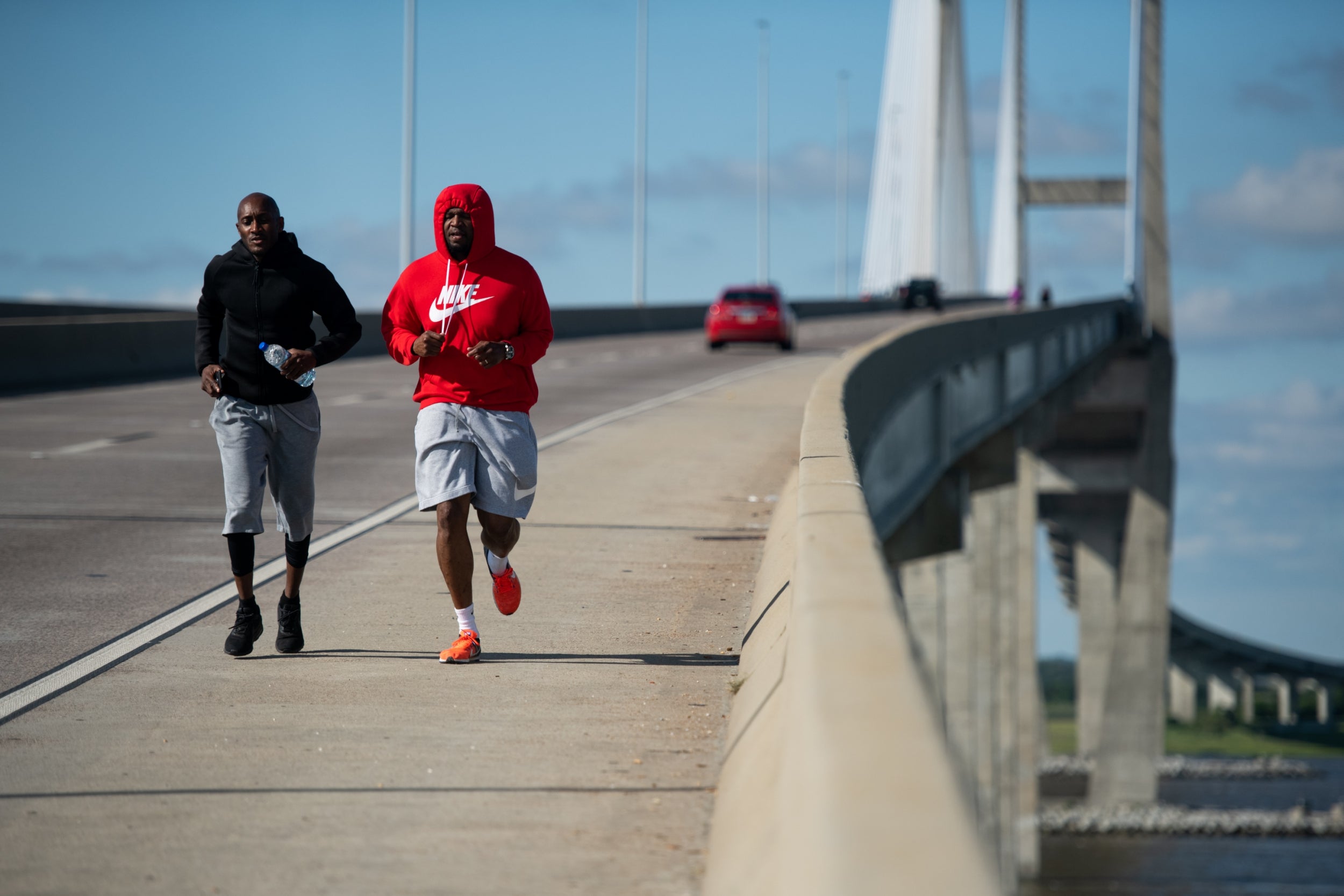 Umoja Spaulding, left, and Ben Butler run across the Sidney Lanier Bridge to honour Ahmaud Arbery in Brunswick, Georgia