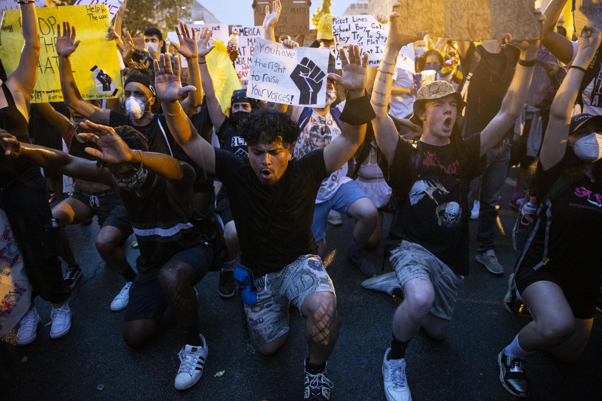 People gather in the rain outside of the White House for a peaceful protest against police brutality