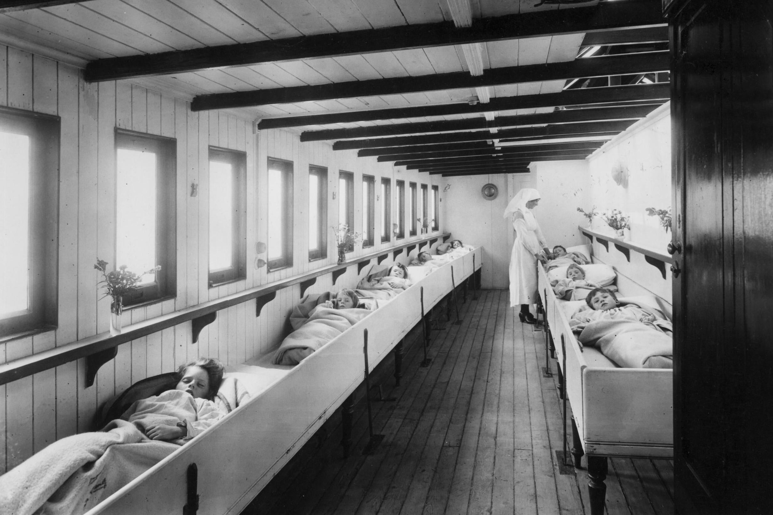 A nurse tends to young patients in a river ambulance for sufferers from infectious diseases such as tuberculosis