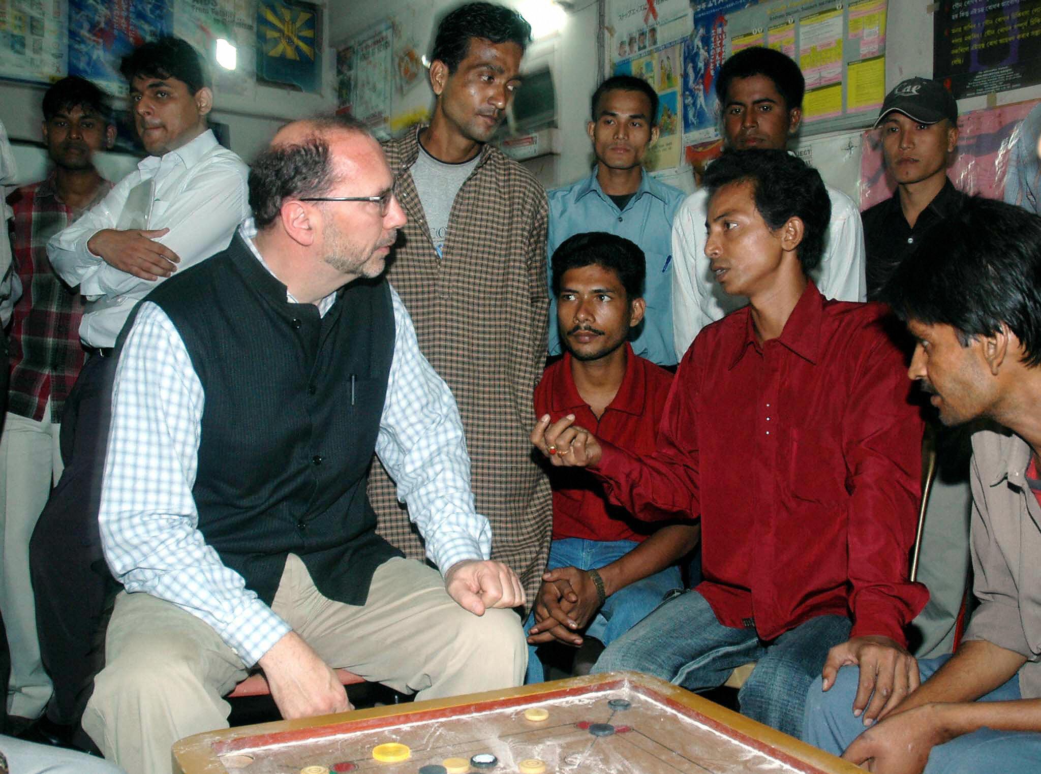 Piot listens to drug users at the head office of the Aids Prevention Society in Guwahati, India, in 2005