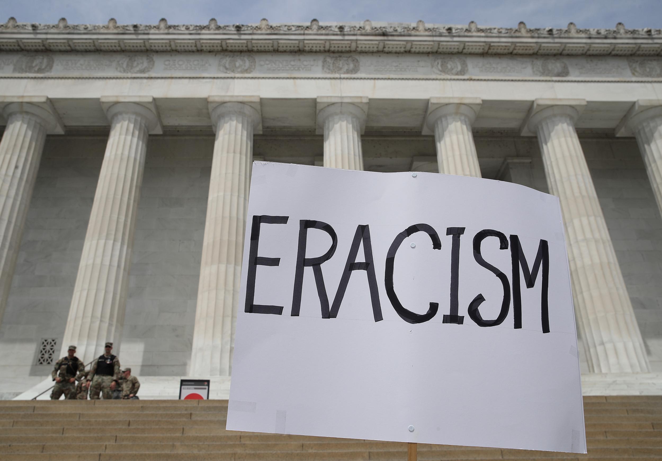 A sign that reads ‘Eracism‘ is posted in front of the Lincoln Memorial during a peaceful protest against police brutality and the death of George Floyd