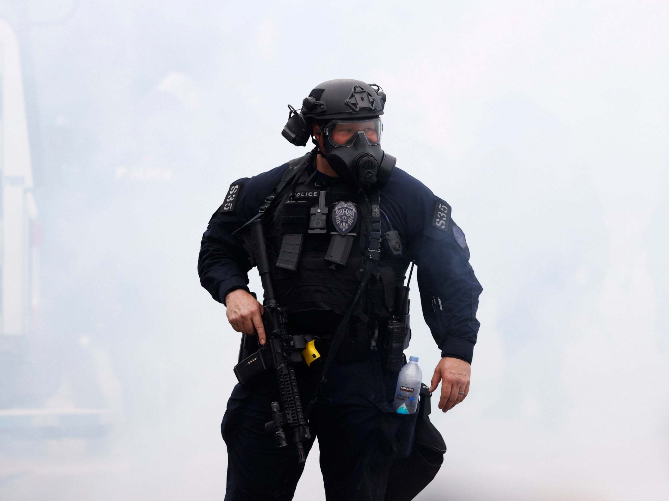 A police officer in Denver, Colorado, is swallowed by a cloud of teargas