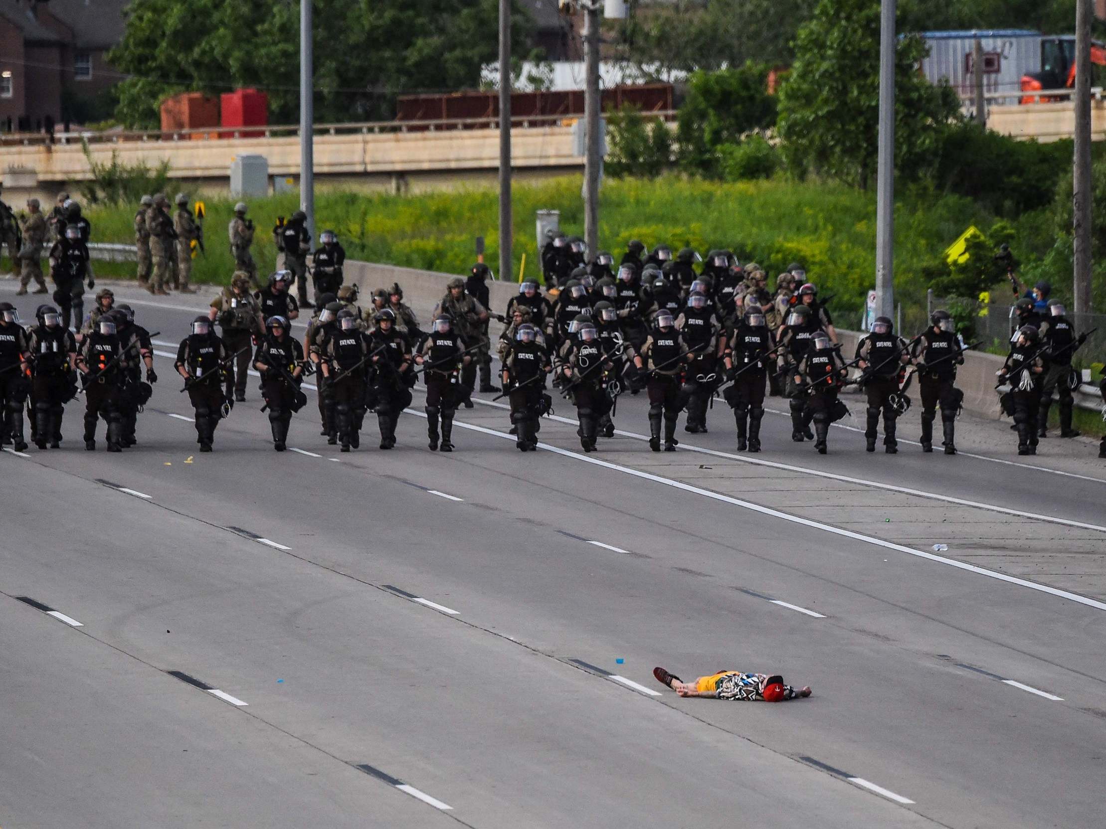 A demonstrator lies in front of police in Minneapolis, where George Floyd was killed (AFP via Getty)