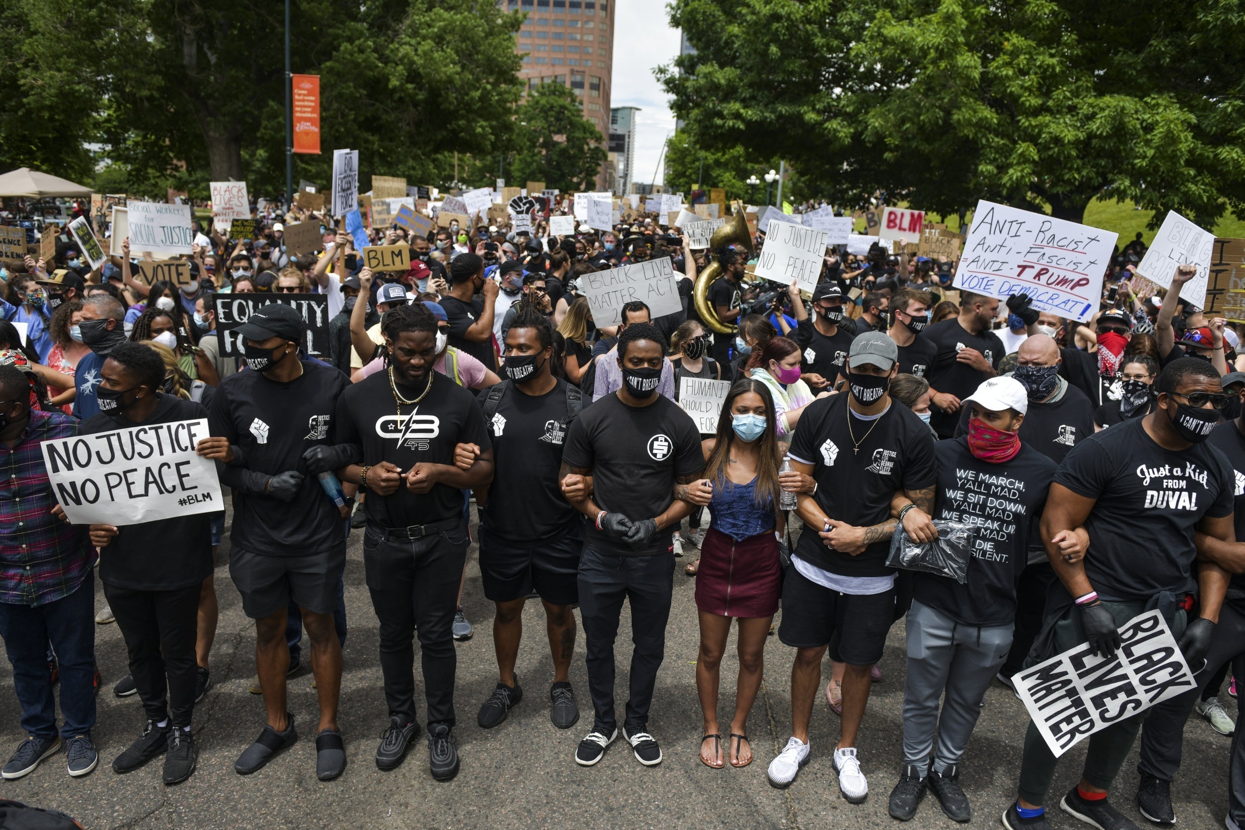 Denver Broncos players join thousands of people protesting the death of George Floyd on June 6 in Denver, Colorado