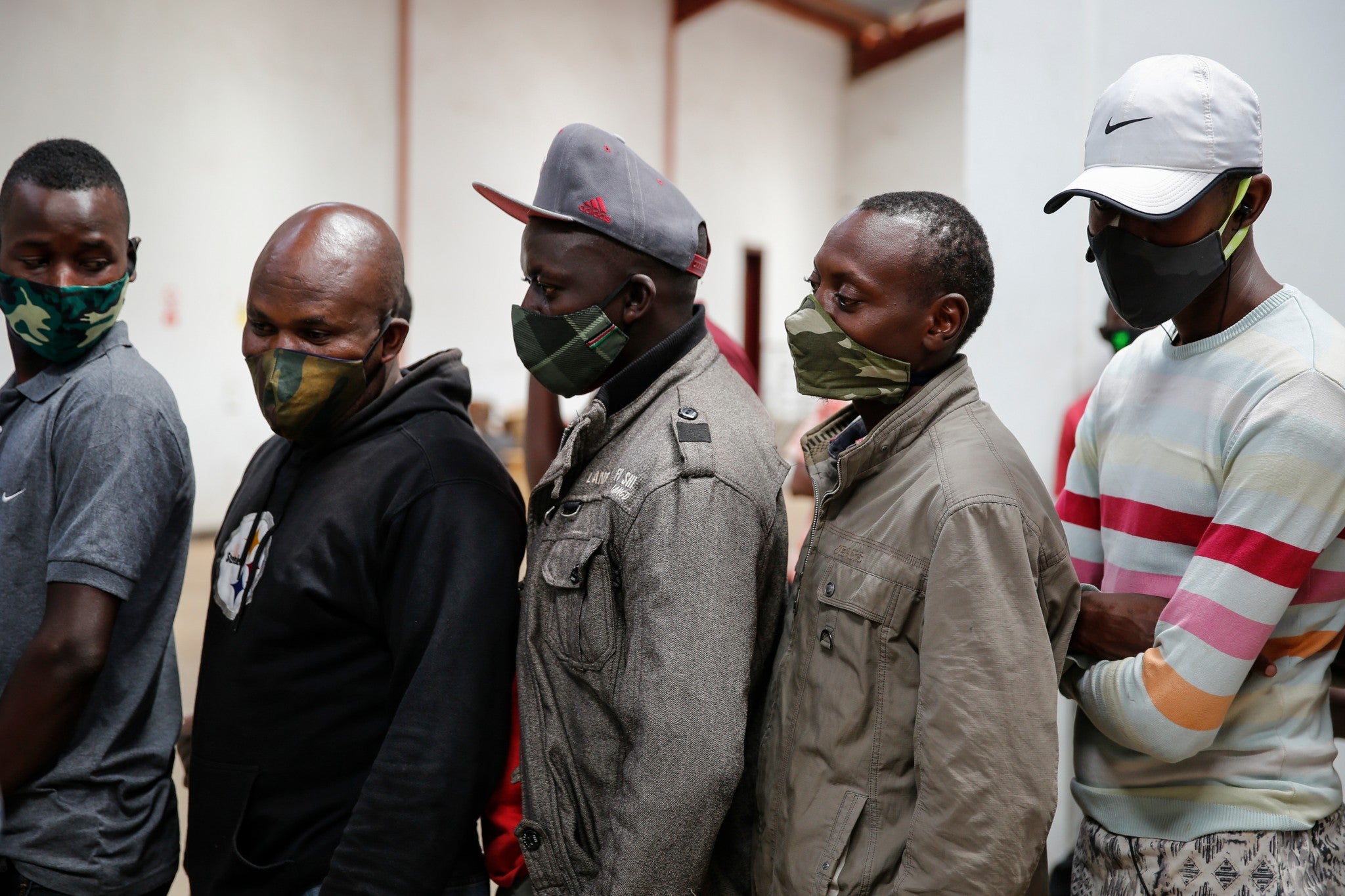 Truck drivers entering Kenya queue to be tested for the coronavirus on the Kenya side of the Namanga border crossing with Tanzania