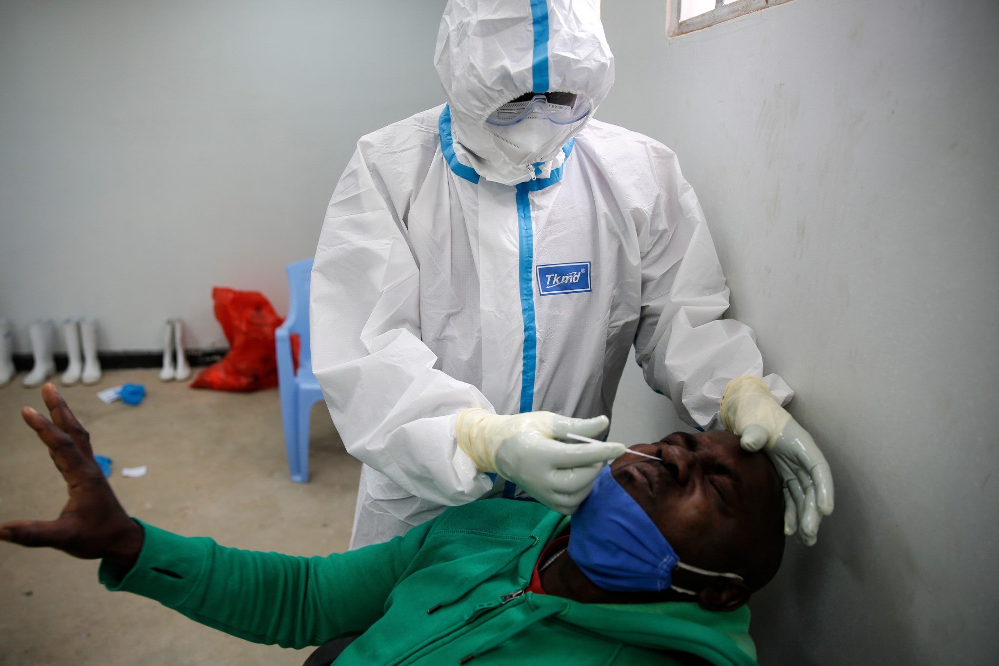 A Tanzanian truck driver reacts as he is tested for the coronavirus