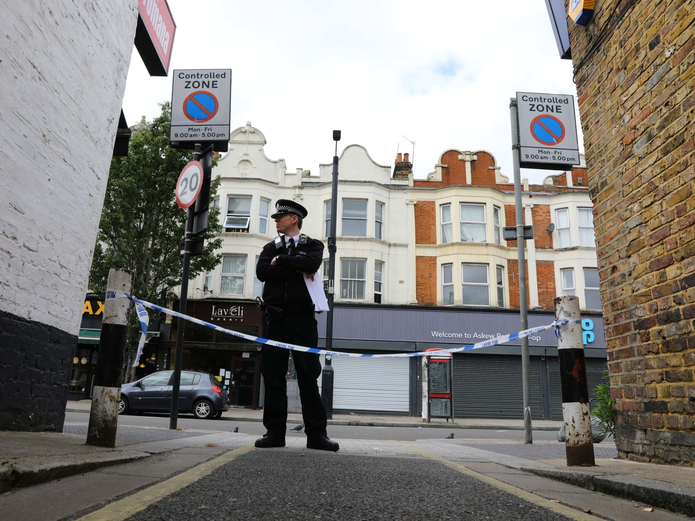 Police at the scene at Askew Road, Shepherd's Bush, west London, where a man in his 20s was shot dead, 8 June 2020.