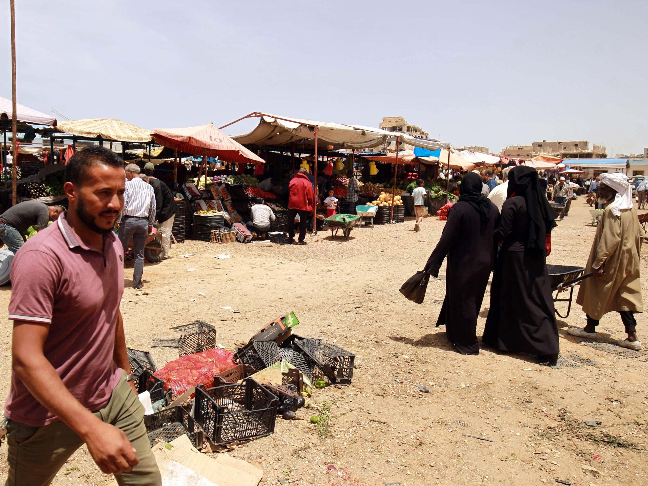 People shop at a vegetable market in the eastern Libyan port city of Benghazi