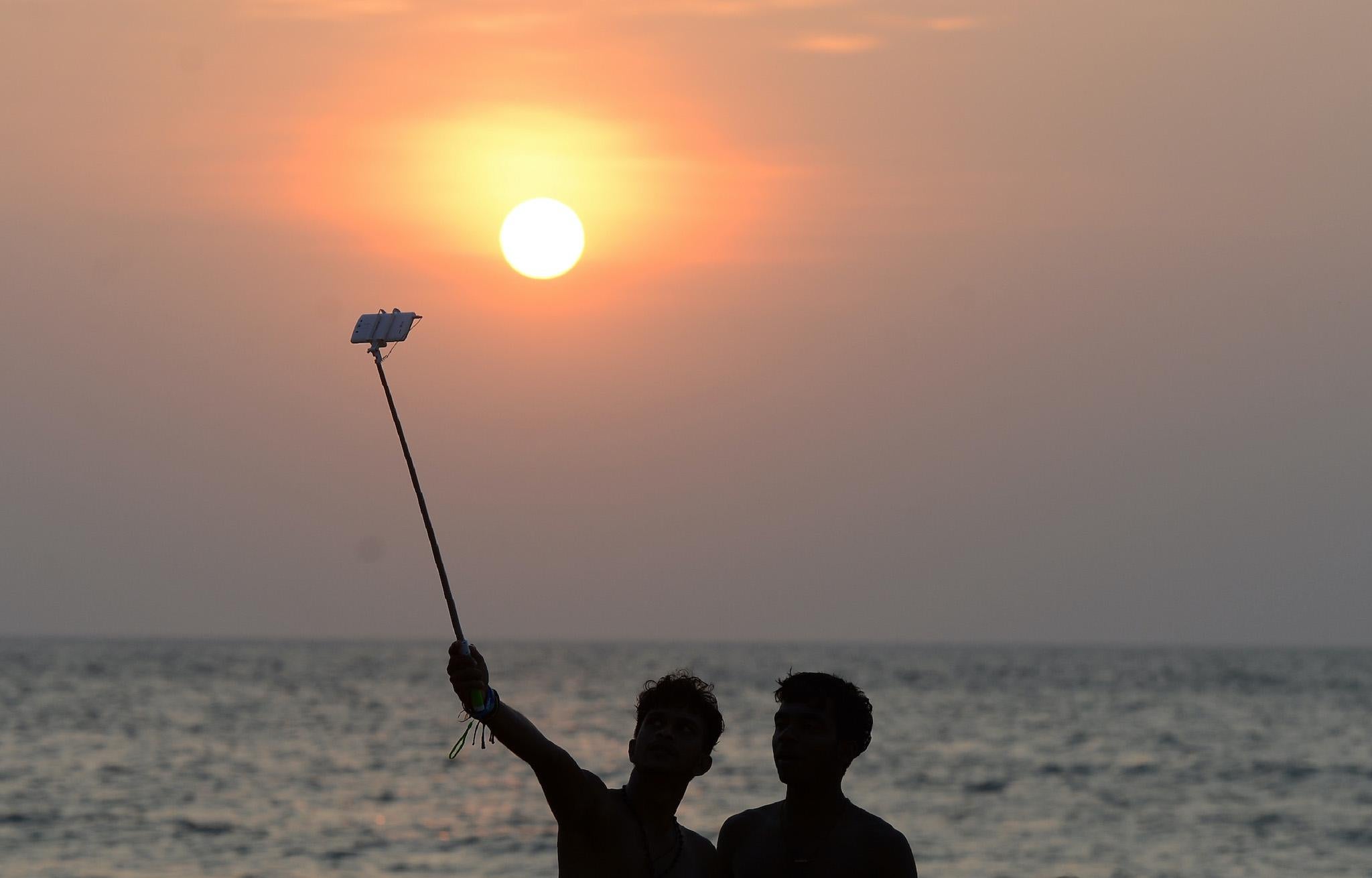 A Sri Lankan man takes a selfie on the beach in the capital Colombo on December 6, 2016