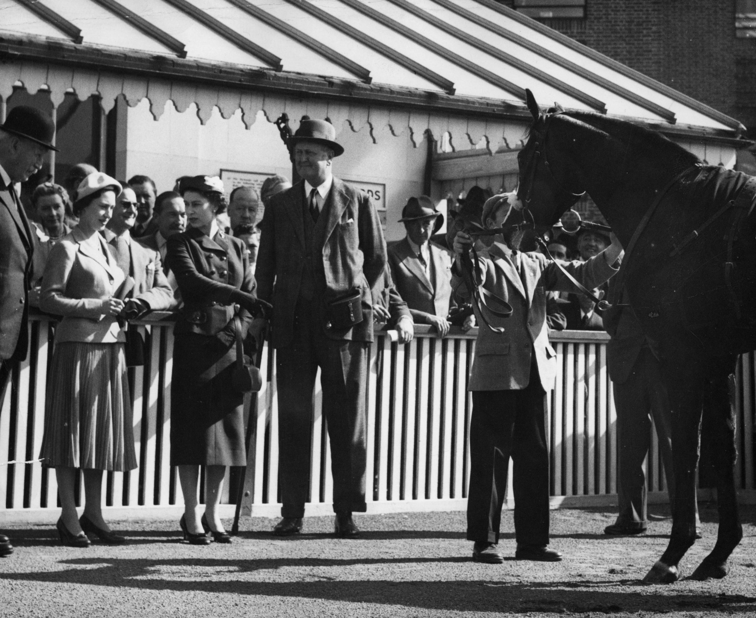 The Queen points to her colt Doutelle, who had just won the 2,000 Guineas Trial Stakes at Kempton Park races, 20 April 1957