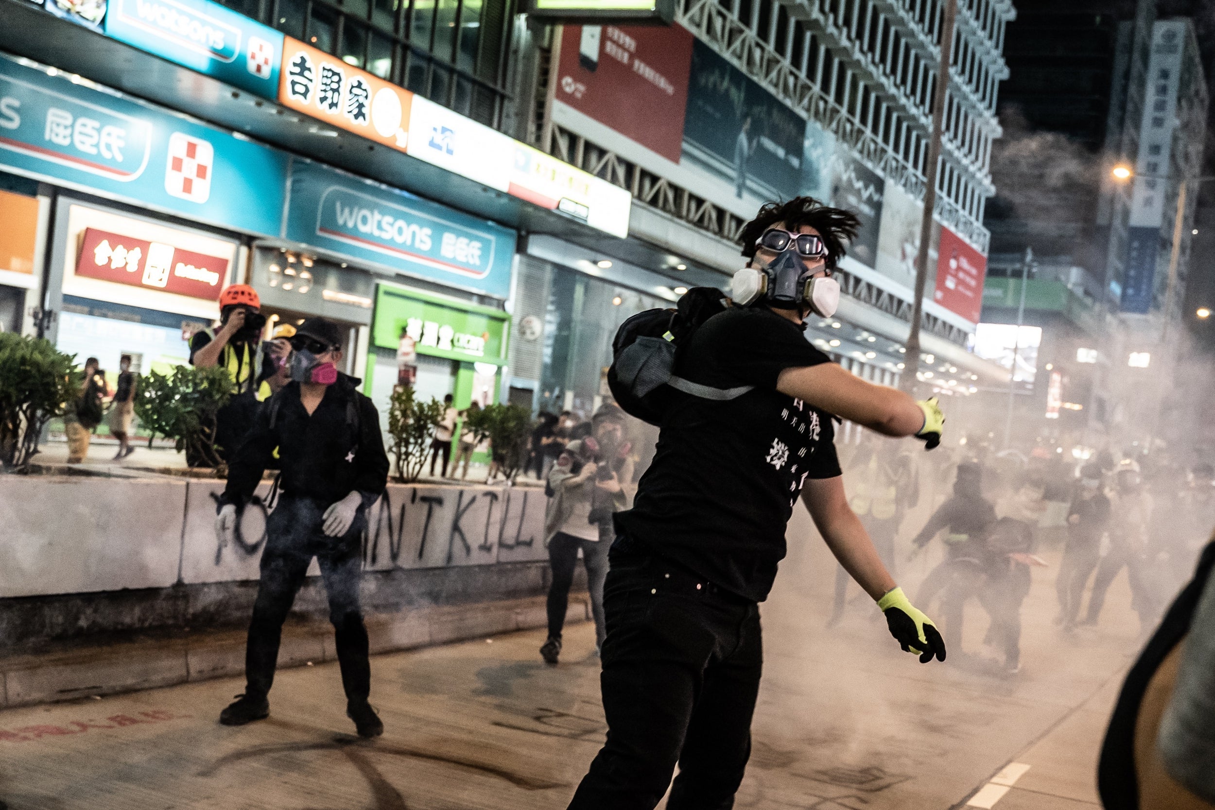 Pro-democracy protesters react after police fire teargas in Mongkok district in Hong Kong (Getty)