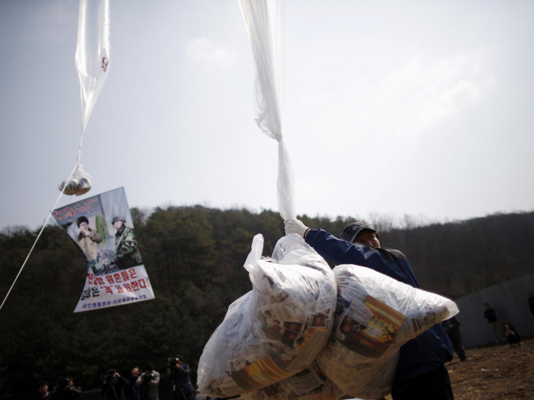 a North Korean defector living in the South and leader of an anti-North Korea civic group, holds a balloon containing leaflets denouncing North Korean leader Kim Jong Un