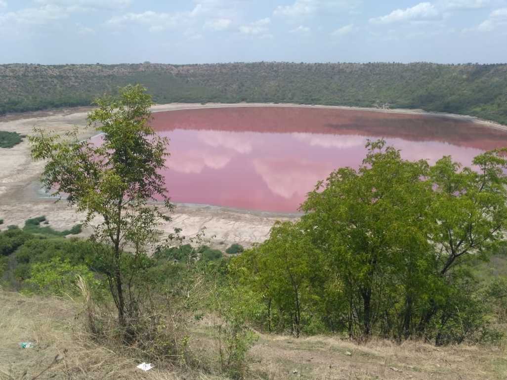 The crater-lake is usually green, but in recent weeks it has turned a pinky-red