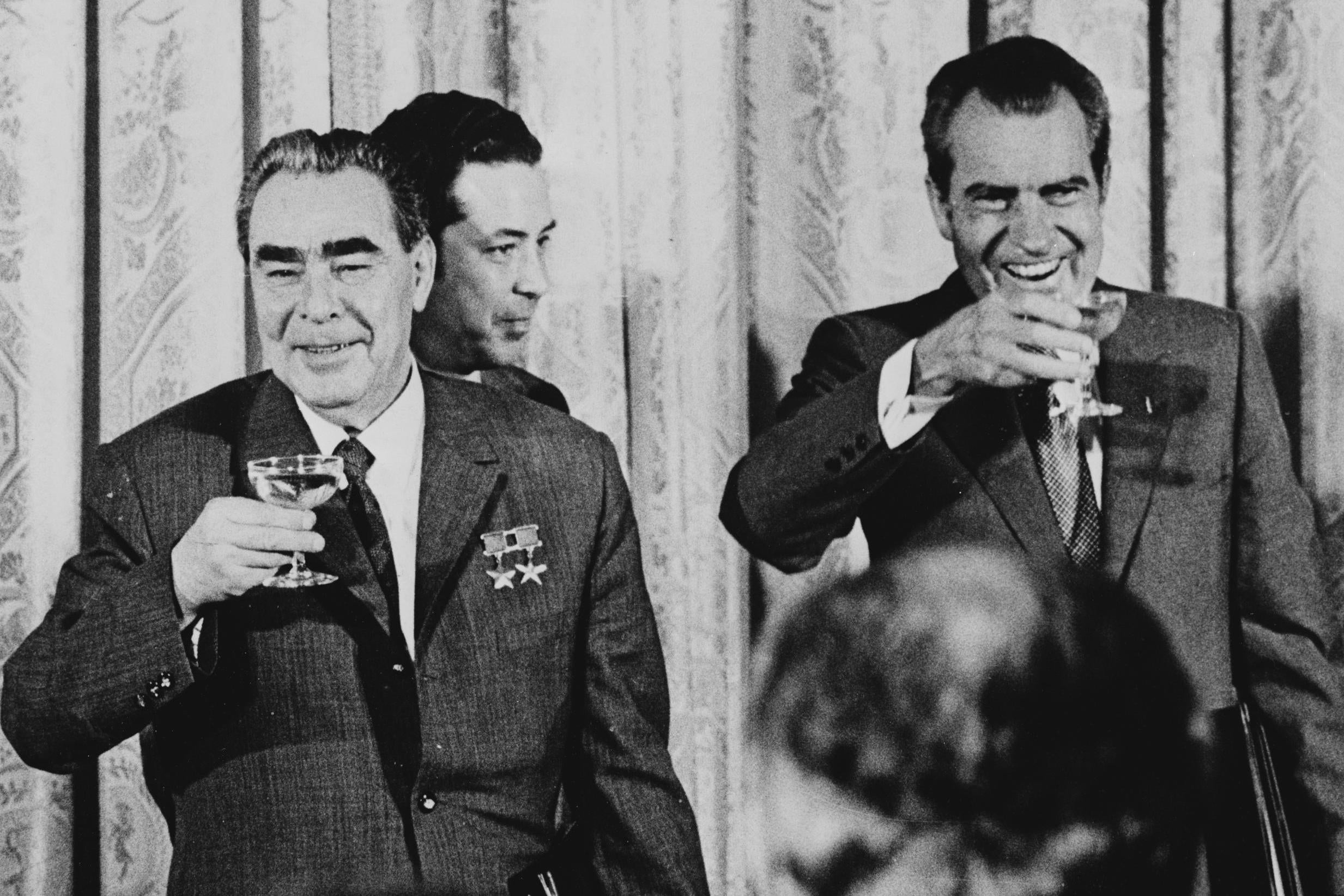 Nixon (right) and Russian leader Leonid Brezhnev share a champagne toast after signing treaties to limit the use and stockpiling of nuclear weapons