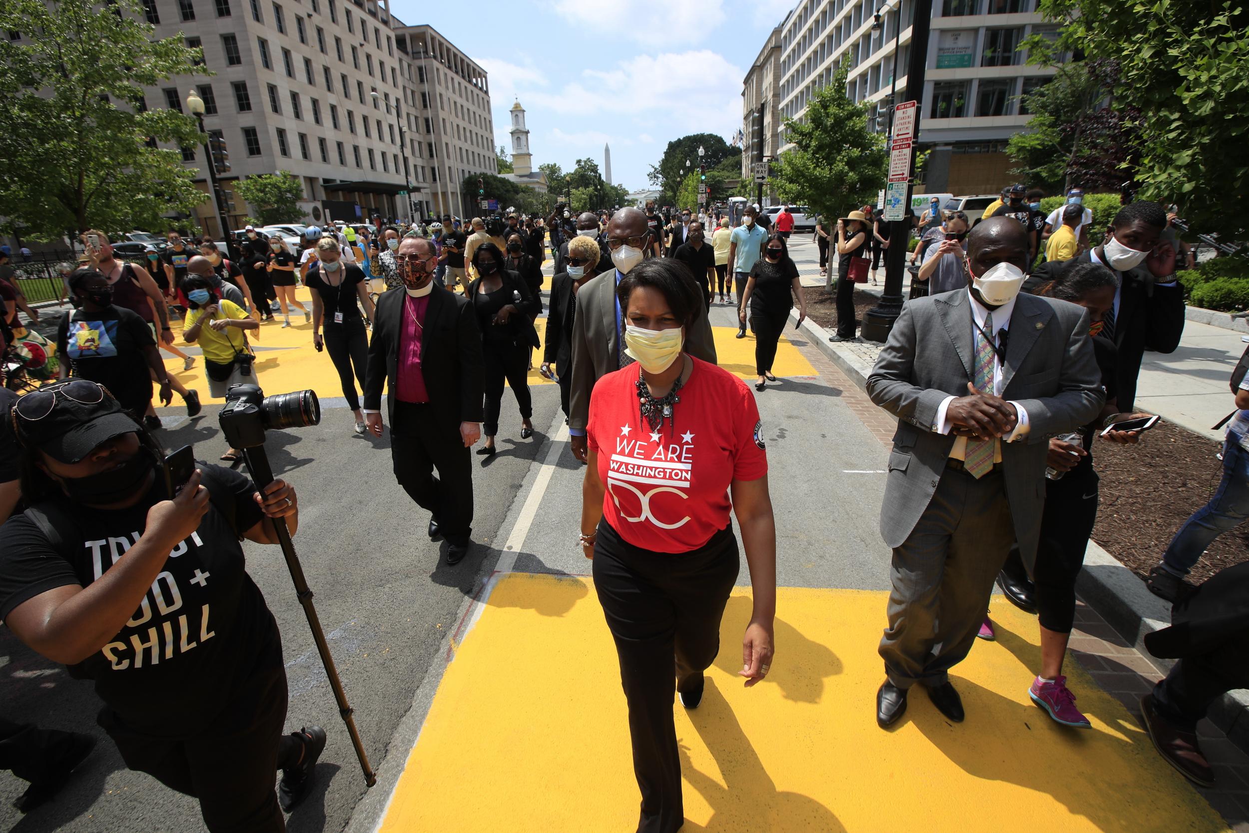 Muriel Bowser walks on the street leading to the White House