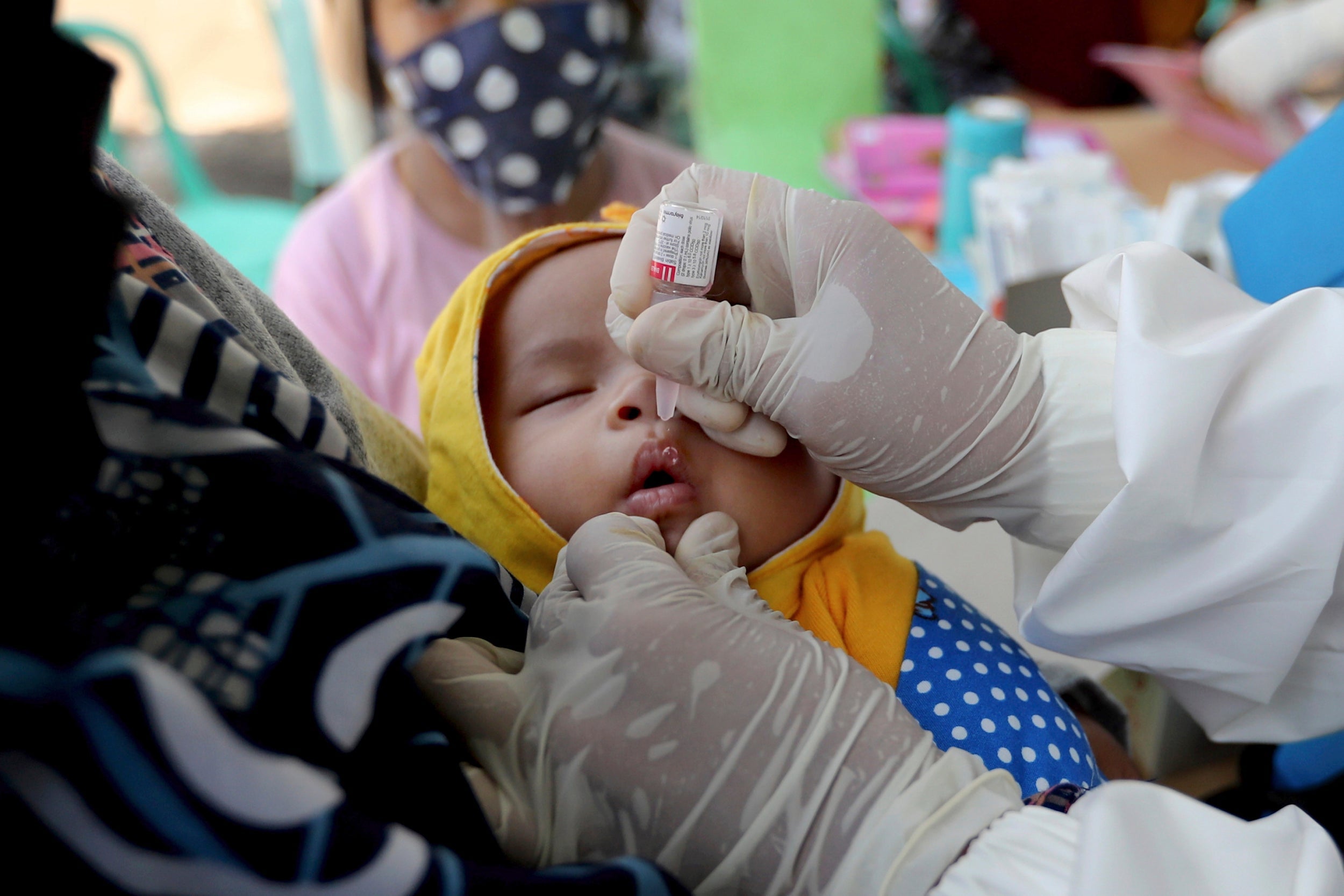A baby receives a polio vaccination in Indonesia