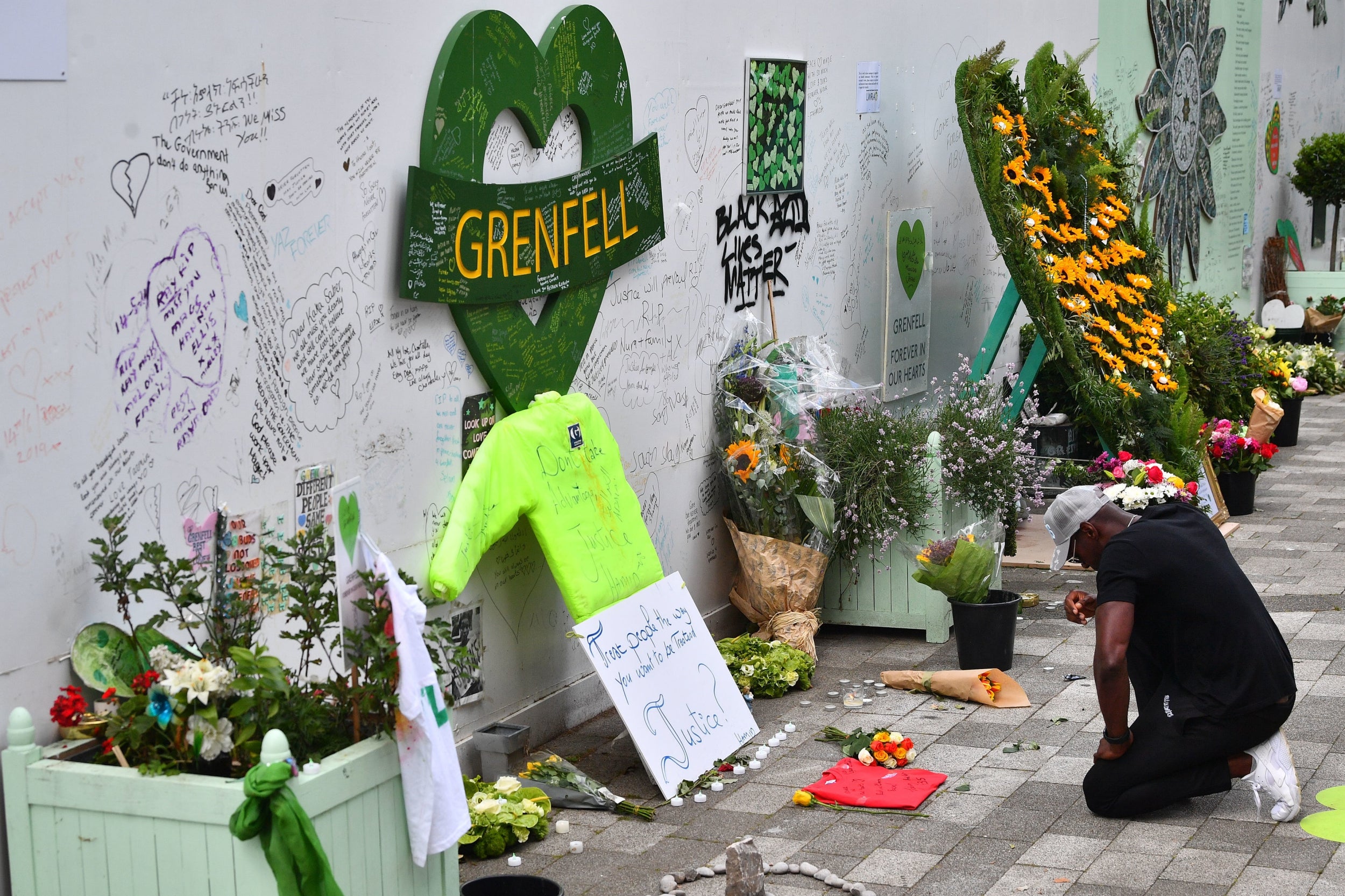 People attend a commemoration to mark the third anniversary of the Grenfell Tower fire in London. The fire claimed 72 lives on 14 June 2017