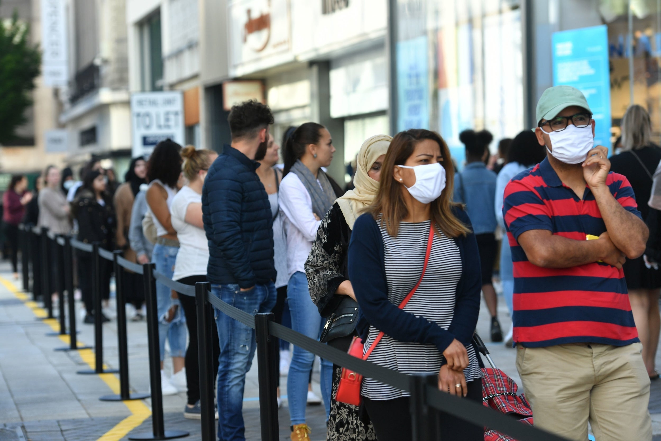 Hundreds of shoppers stand in line ahead of the store opening at Primark in Birmingham, Monday 15 June 2020