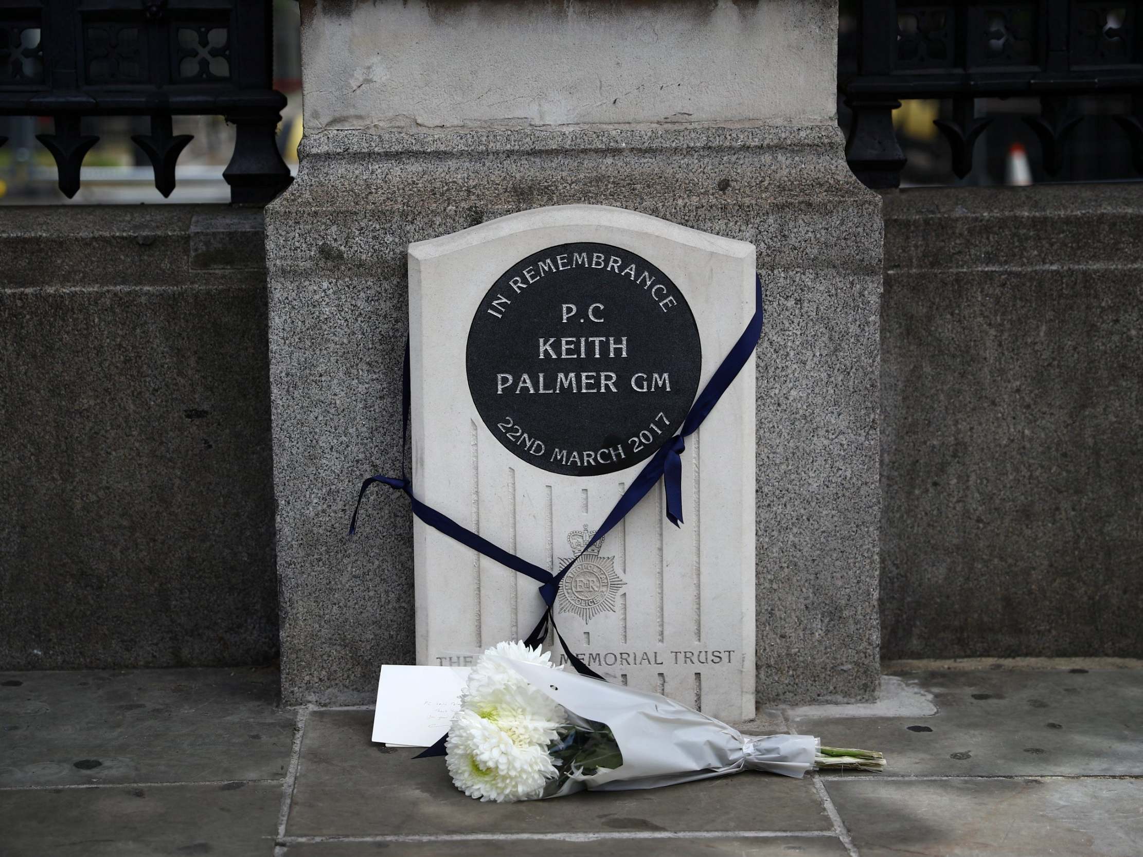 A bouquet of flowers is laid down at the memorial stone for PC Keith Palmer in London