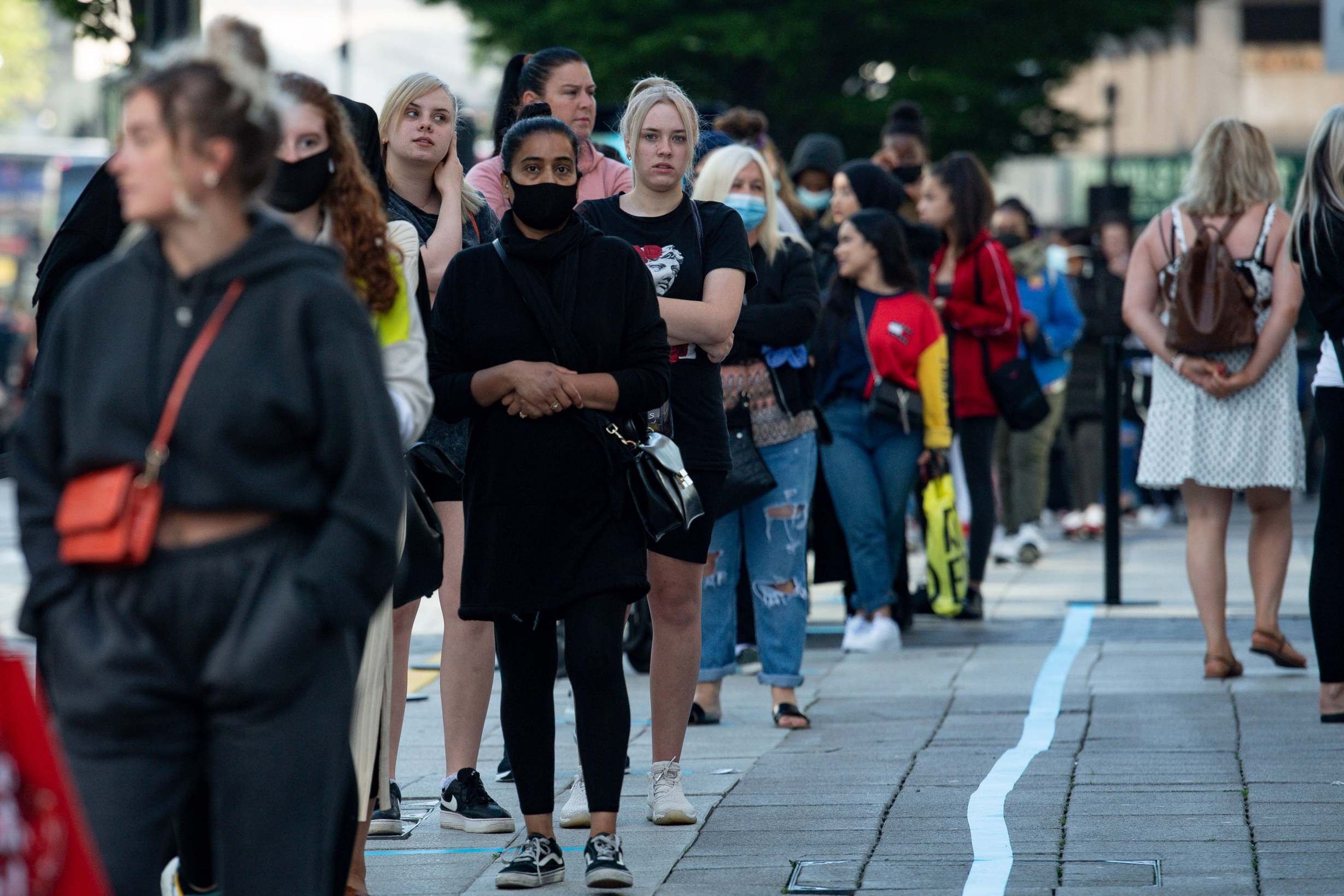 Shoppers queue at Primark in Birmingham after non-essential shops in England reopened their doors to customers last month