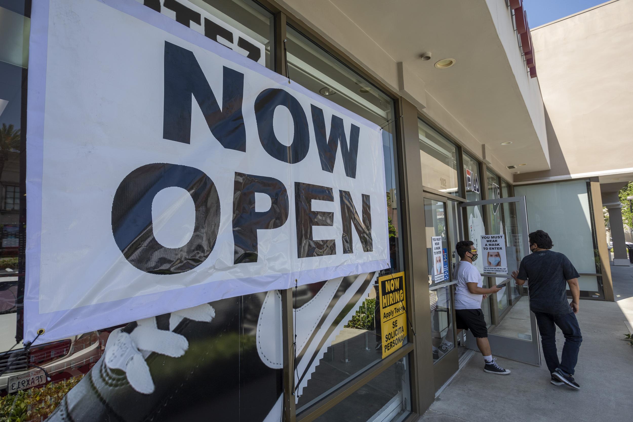 People exit a Shoe City store as Los Angeles County retail businesses reopen while the Covid-19 pandemic continues