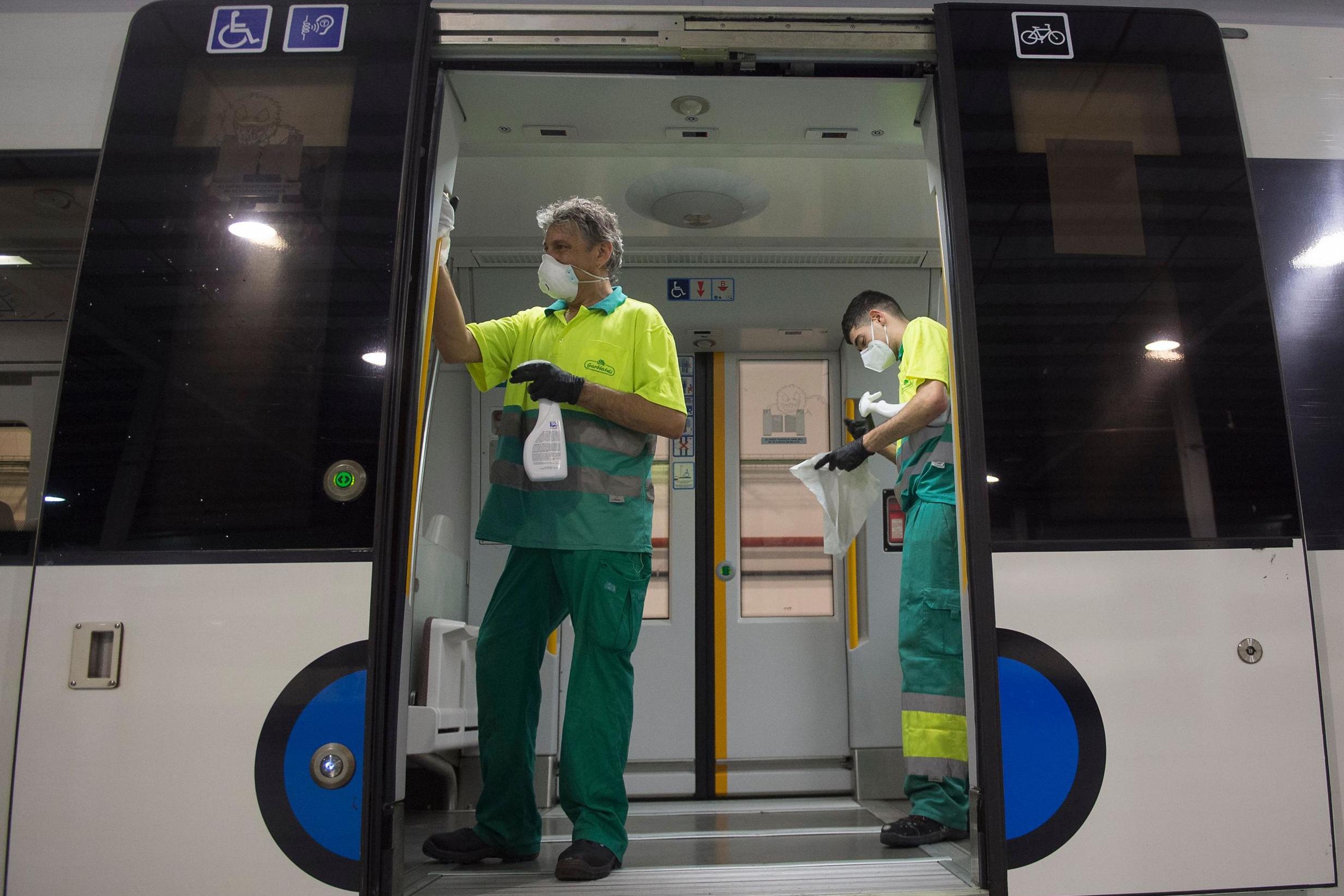 Employees carry out a disinfection of a train of the Basque railway company Euskotren in the Spanish Basque city of Irun in May 2020