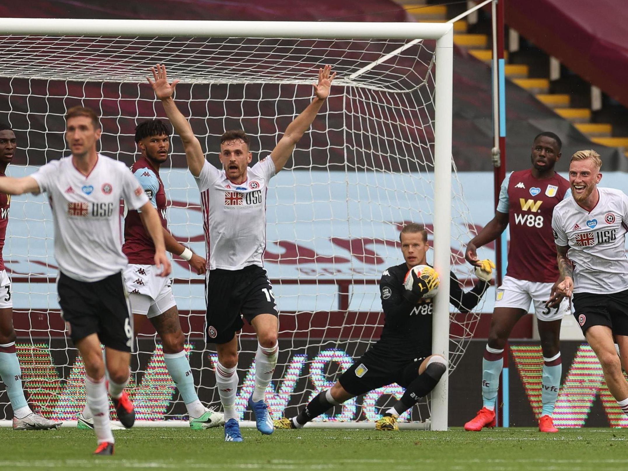 Sheffield United's players react as Aston Villa's Norwegian goalkeeper Orjan Nyland (C) catches the ball (AFP via Getty Images)