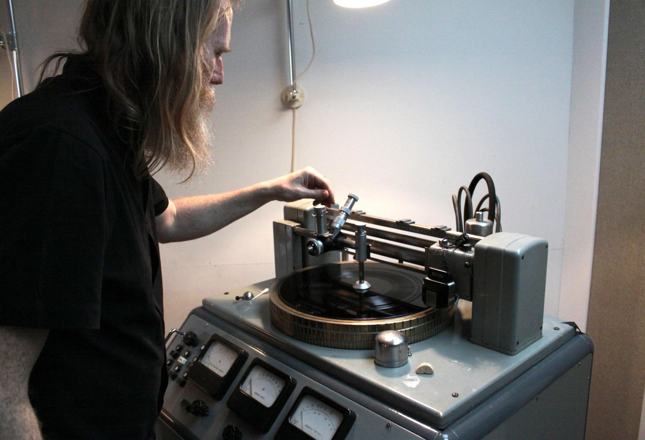 &#13;
Hutchison works with a record cutting machine &#13;