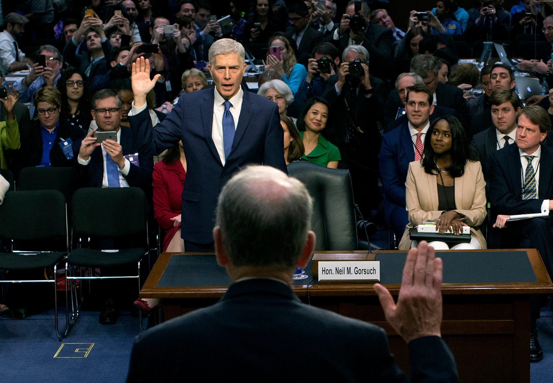 Mary Elizabeth Taylor, right, watches as Neil Gorsuch is sworn in during the first day of his Senate confirmation to the Supreme Court on 20 March, 2017