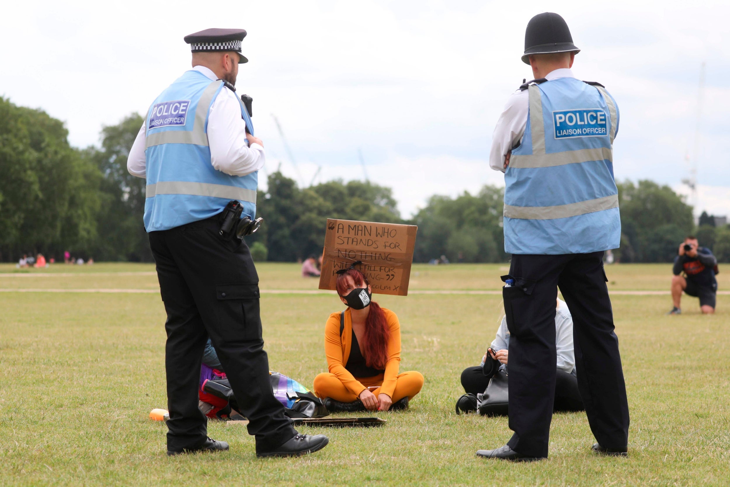 A Black Lives Matter protester talks with police in Hyde Park