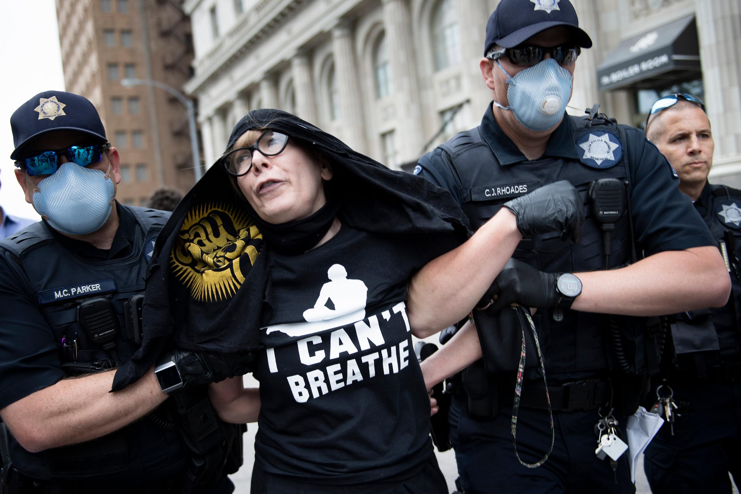 Tulsa Police place Sheila Buck into custody outside Tulsa's BOK Centre before Donald Trump's campaign rally on 20 June.