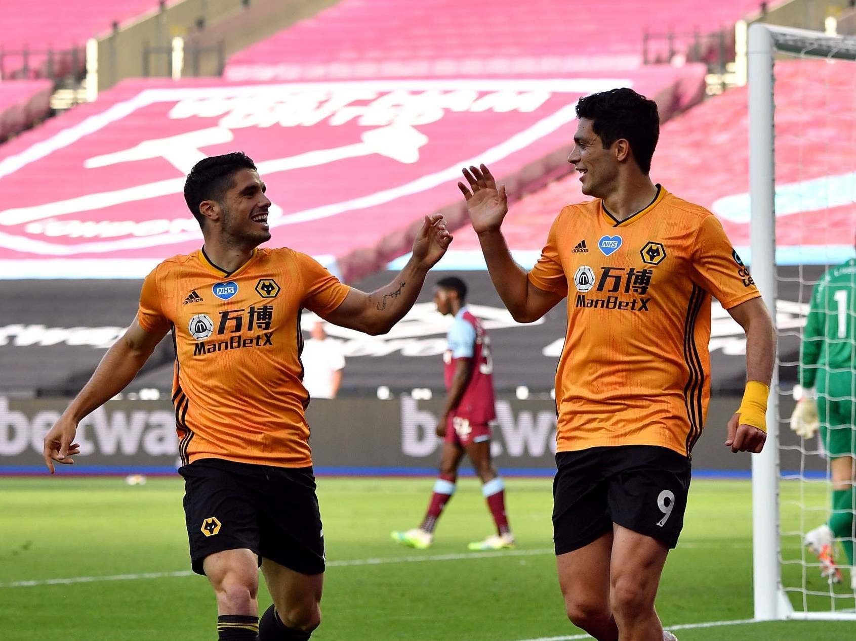 Pedro Neto and Raul Jimenez celebrate victory