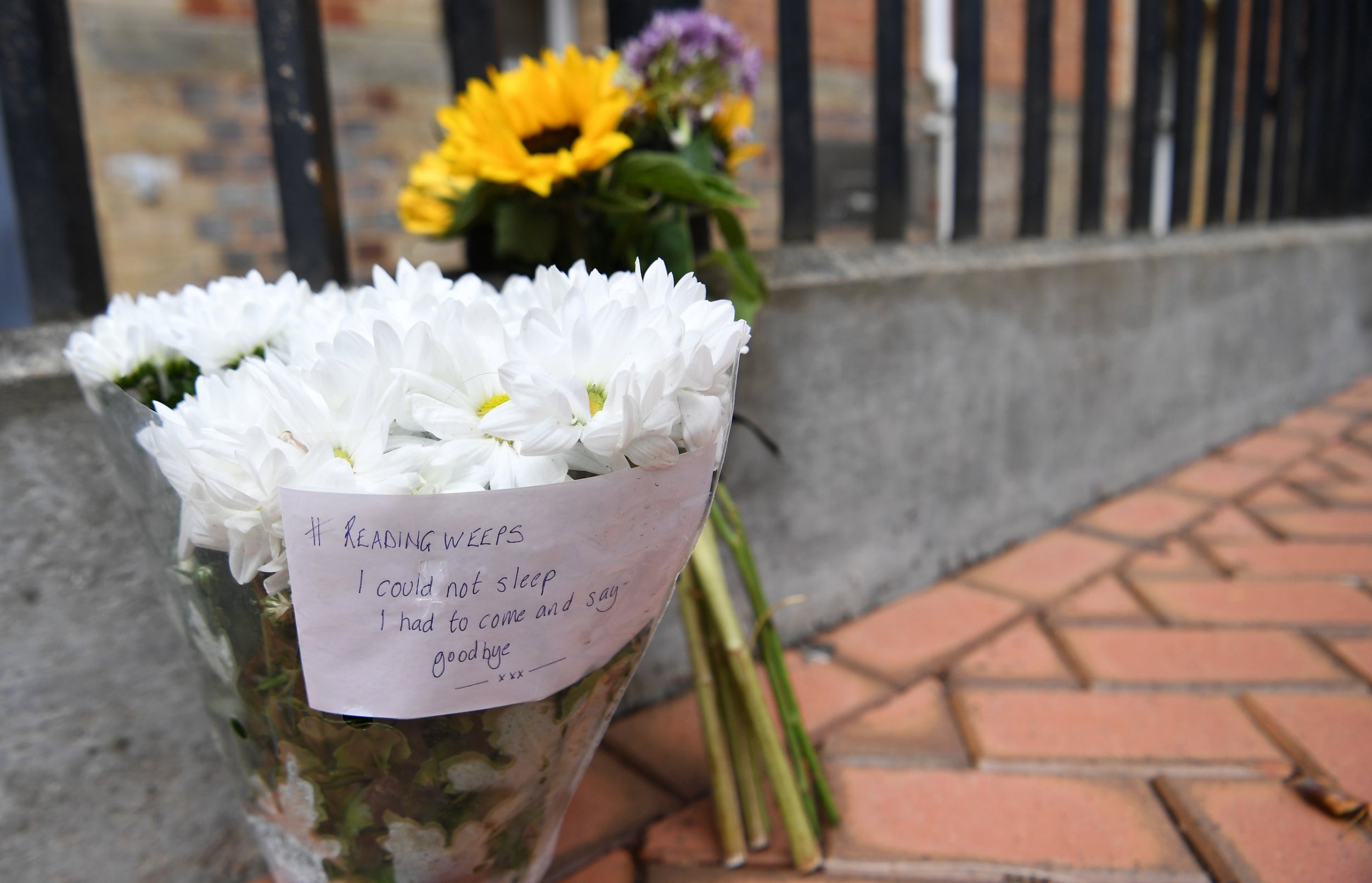 Flowers are laid close to the scene where three people were stabbed in Forbury Gardens in Reading